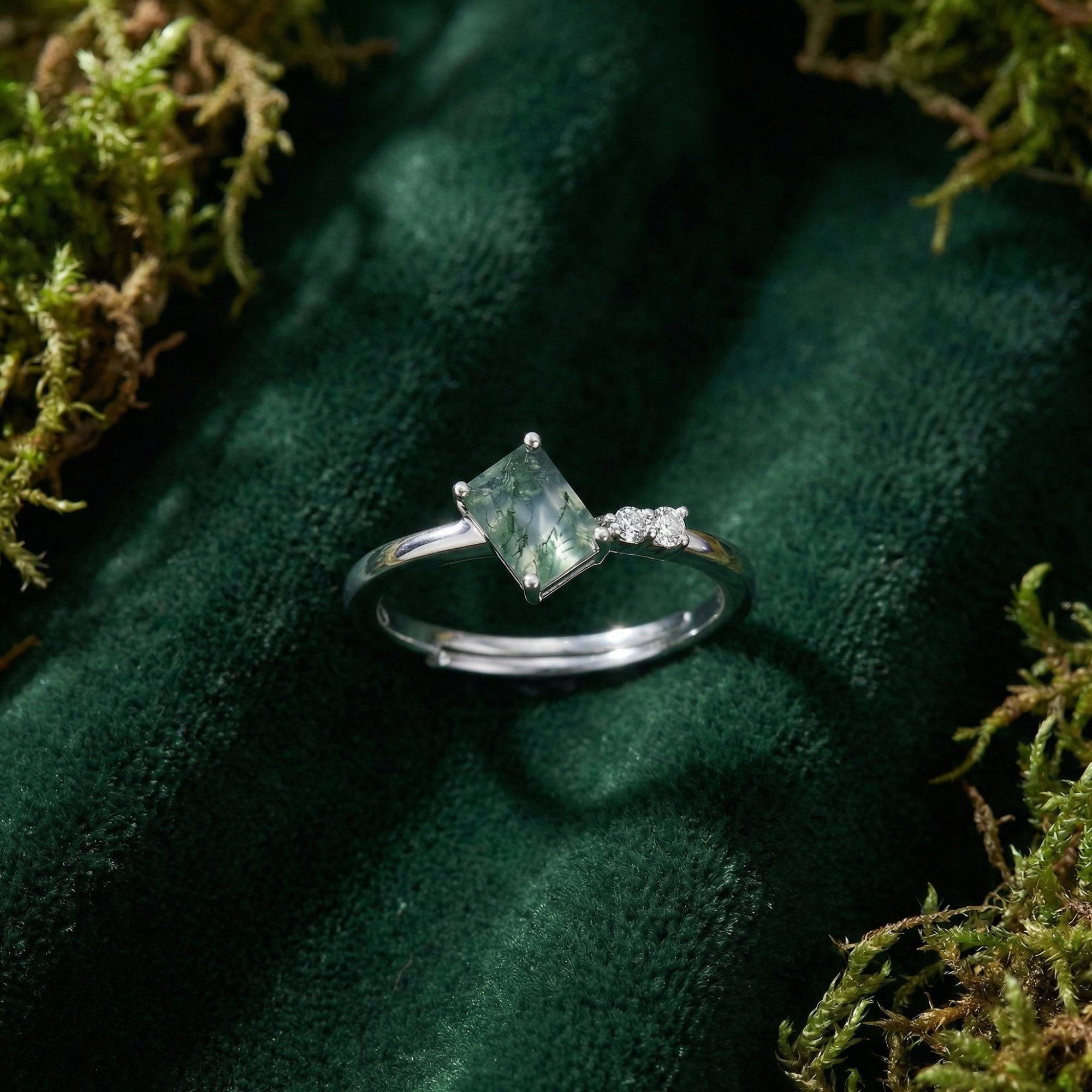 Adjustable rectangular moss agate ring with trio accents in S925 sterling silver on green velvet and moss.