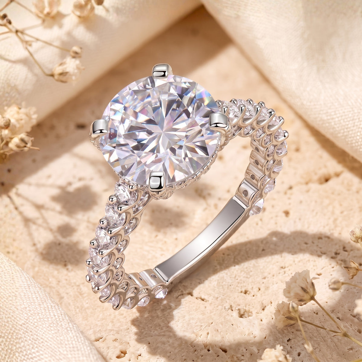 Close-up top view of a silver ring with a large round-cut central stone and accent-lined band.