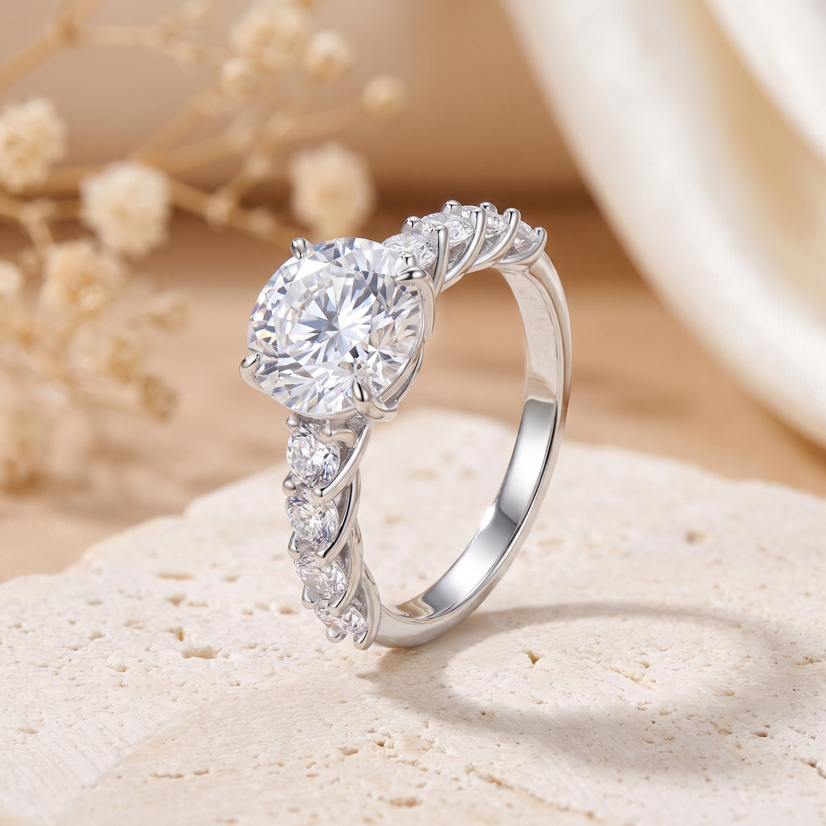 Close-up of a silver ring with a large round center stone and rows of round accent stones along the band.