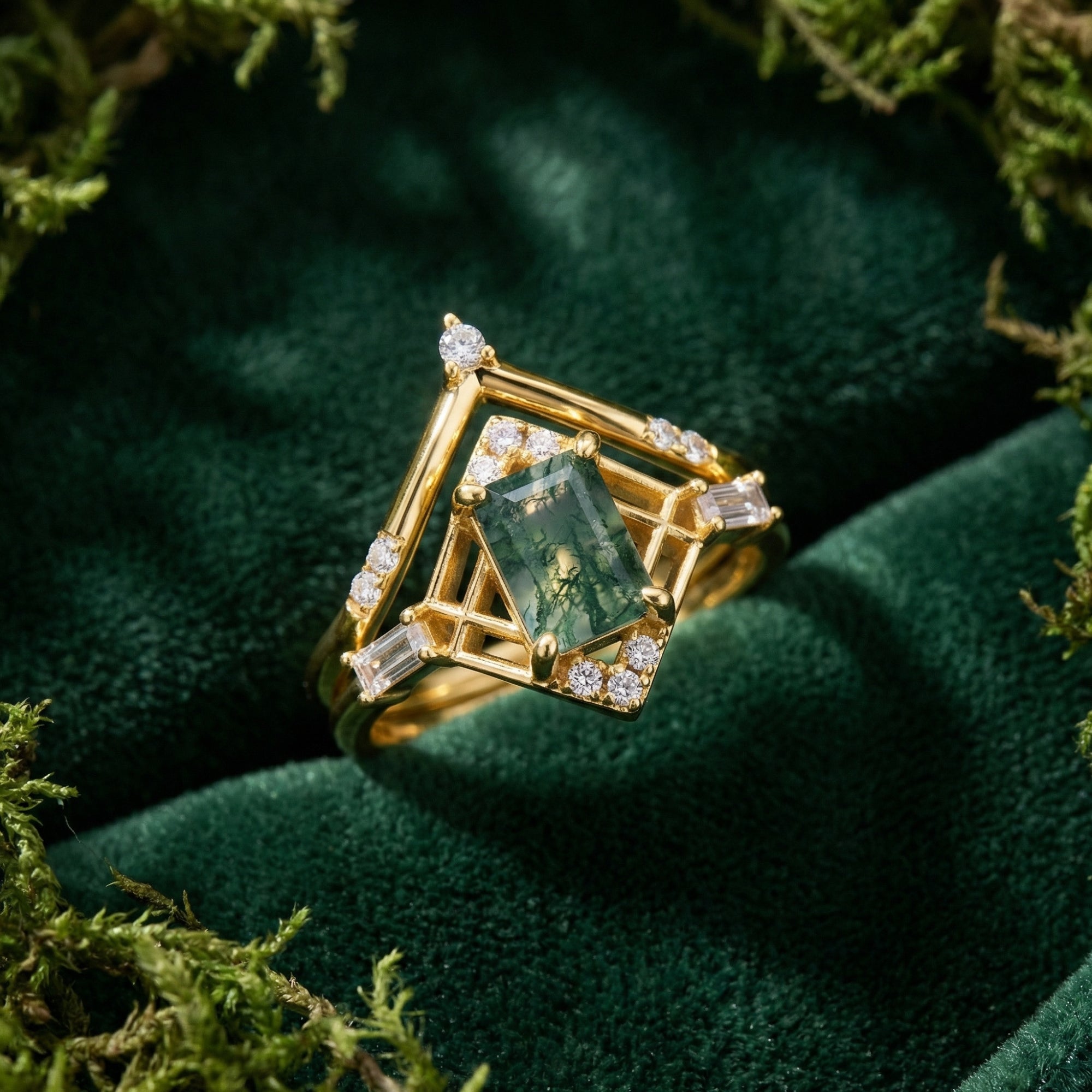 Gold-plated S925 moss agate ring set with a kite-shaped geometric frame and chevron band on green velvet.