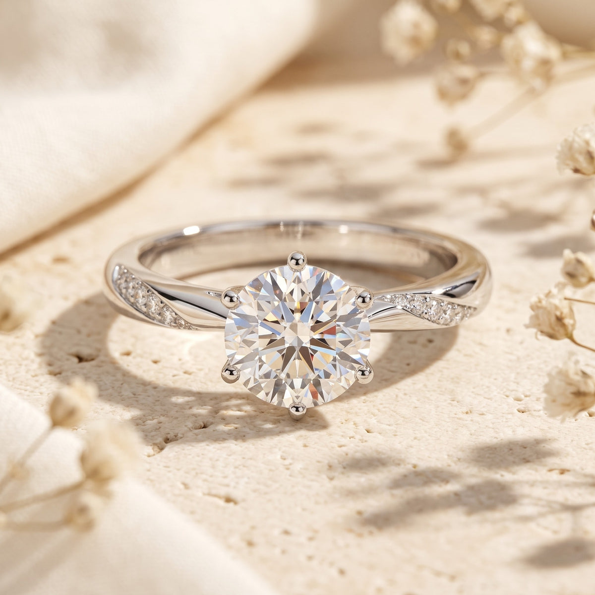 Front close-up of a silver-tone ring with a round center stone, six-prong setting, twisted band, and side accents.