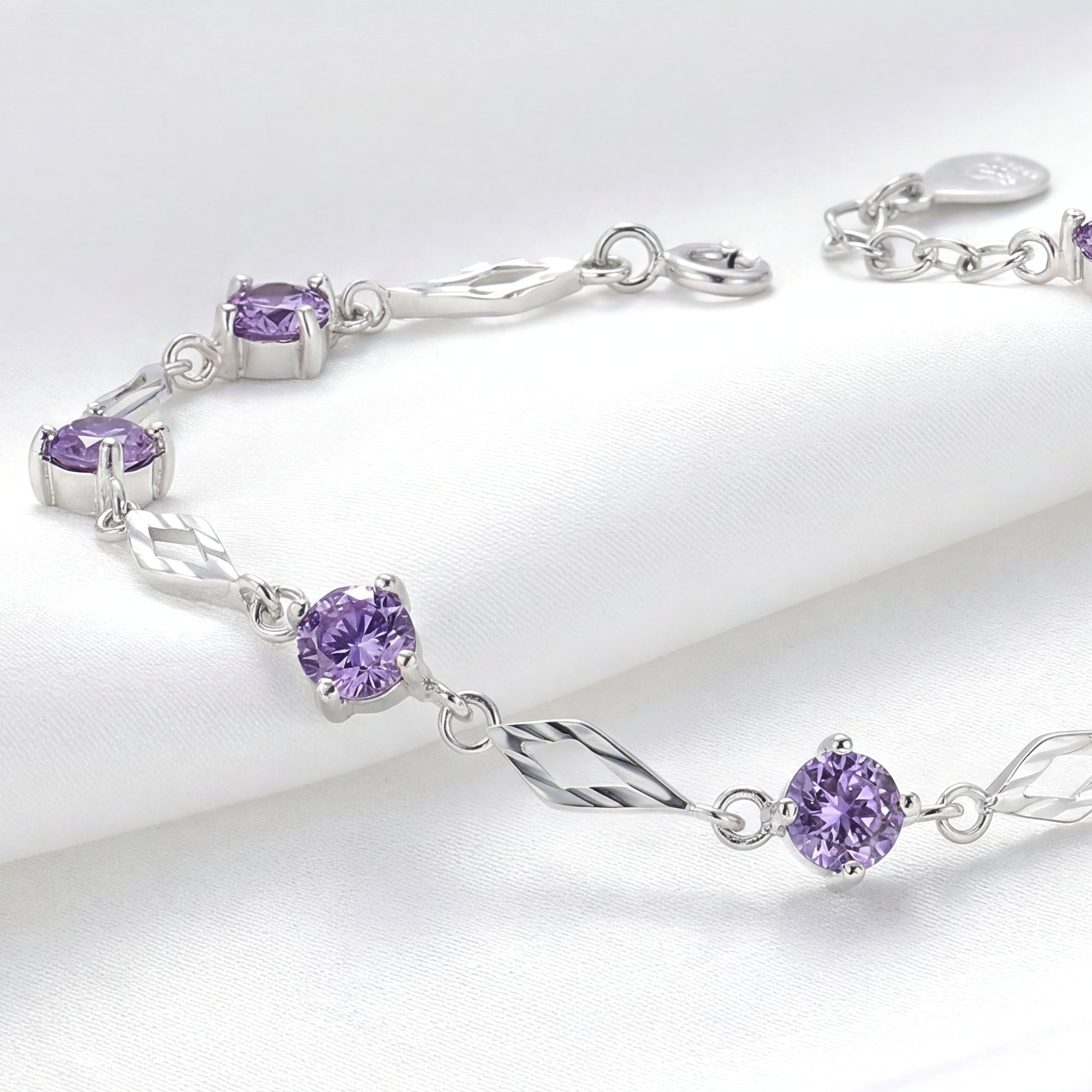 Close-up of round-cut simulated amethysts and diamond-shaped sterling silver links on the Lyris bracelet.
