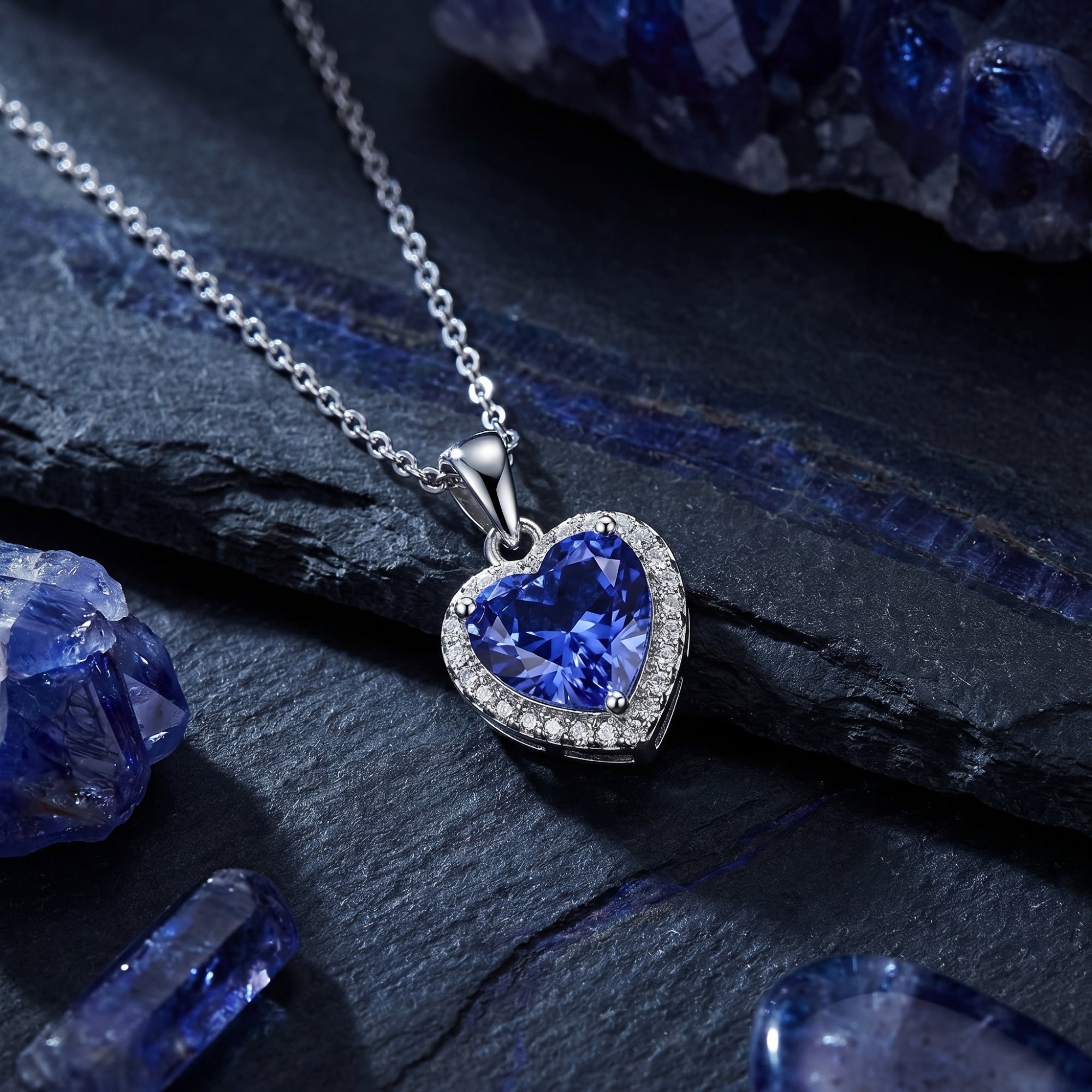 Close-up of a heart-cut tanzanite pendant with a zircon halo setting on a sterling silver chain.