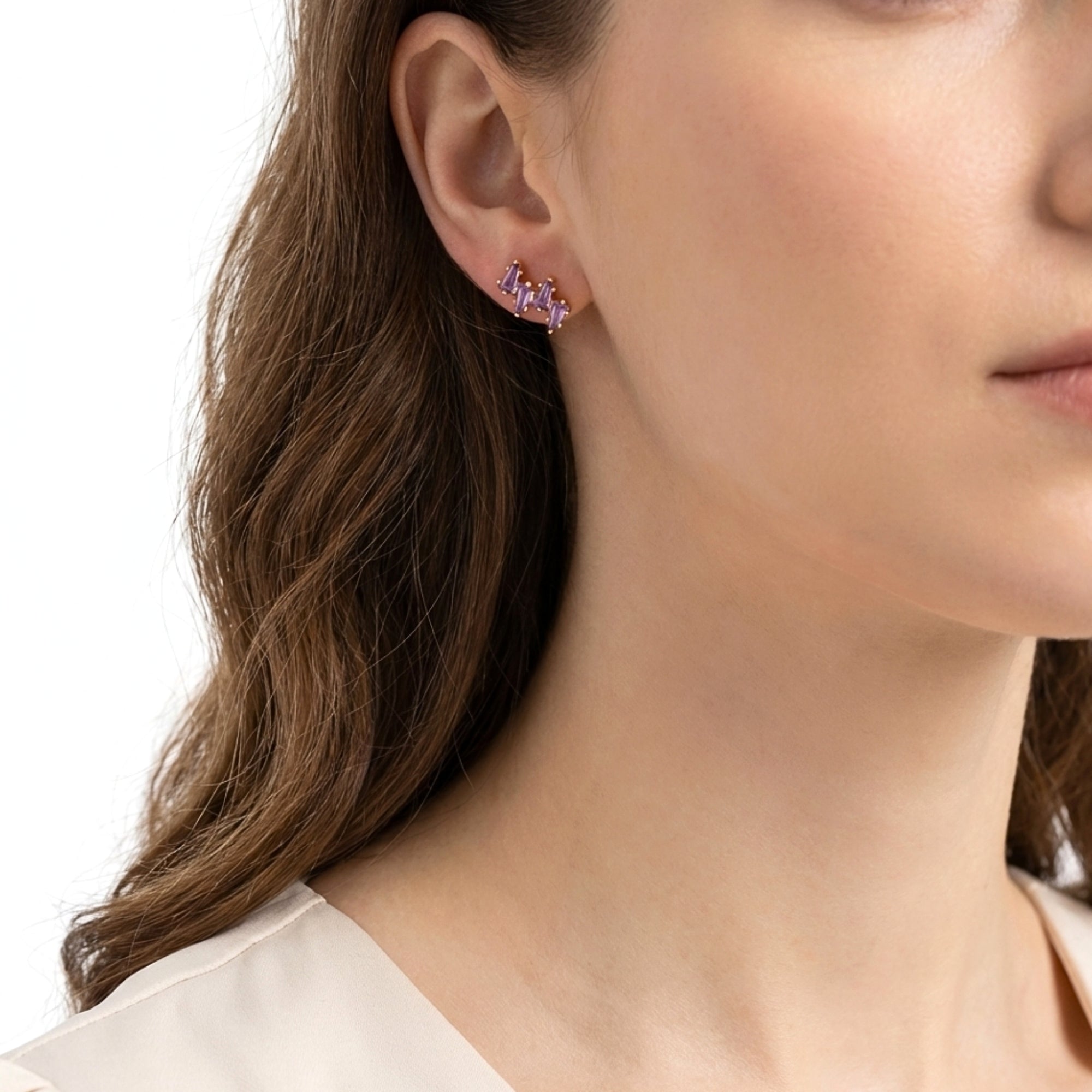 Model wearing the Callista cluster stud earring in 18K gold vermeil with purple simulated amethyst stones.