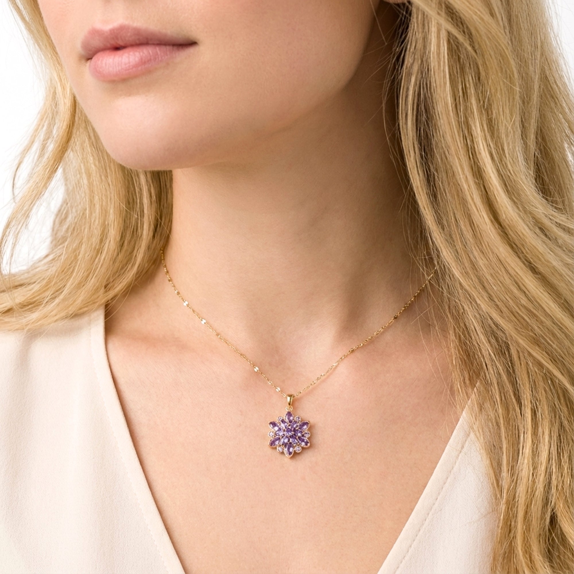 Model wearing the gold-finished stainless steel Floriana pendant necklace with purple simulated amethyst stones.