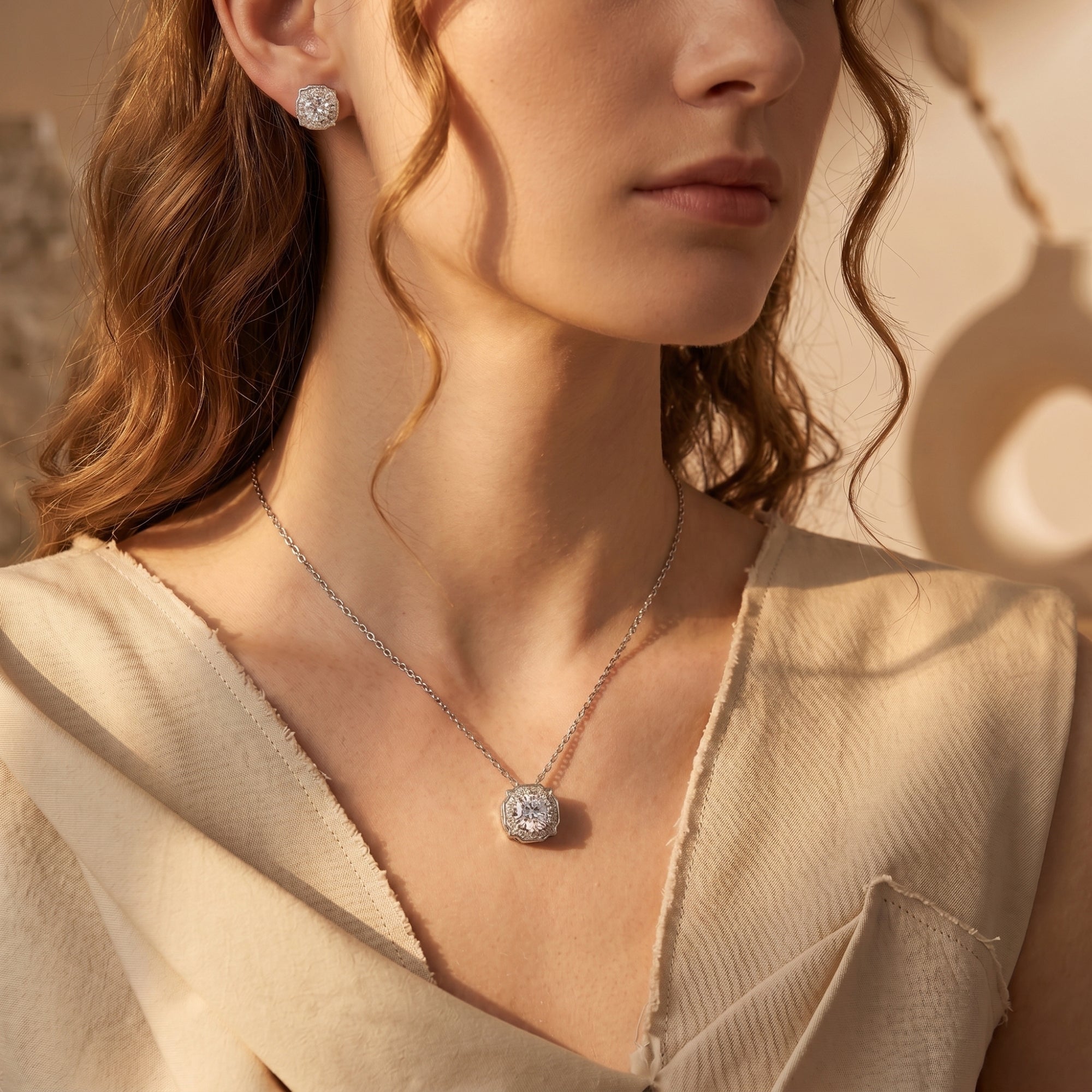 Model wearing the Aurestella silver moissanite halo jewelry set with a round-cut pendant and matching earrings.