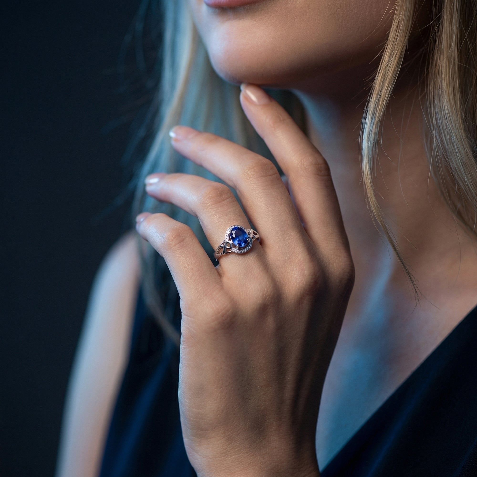 Model wearing the oval cut natural tanzanite ring in 18K white gold with diamond accents.