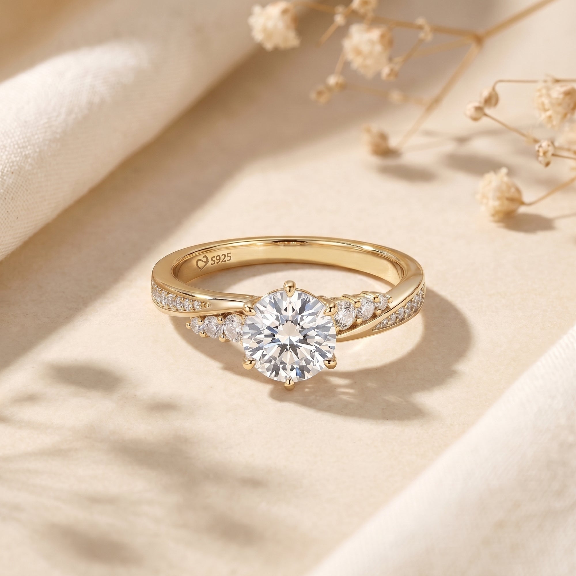 Yellow gold Nicolette ring featuring a 2ct round-cut moissanite on a neutral lifestyle background.