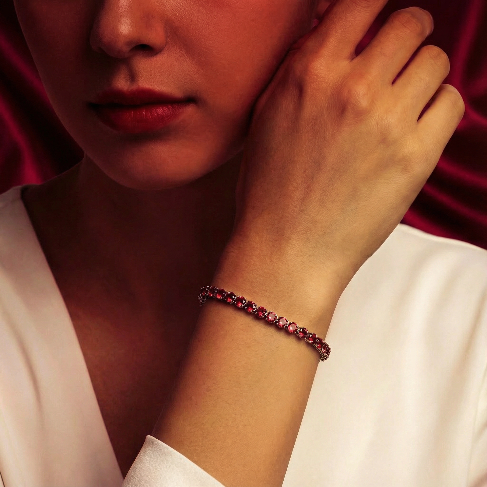 Lifestyle view of a woman wearing the Adalira red simulated ruby tennis bracelet in stainless steel.