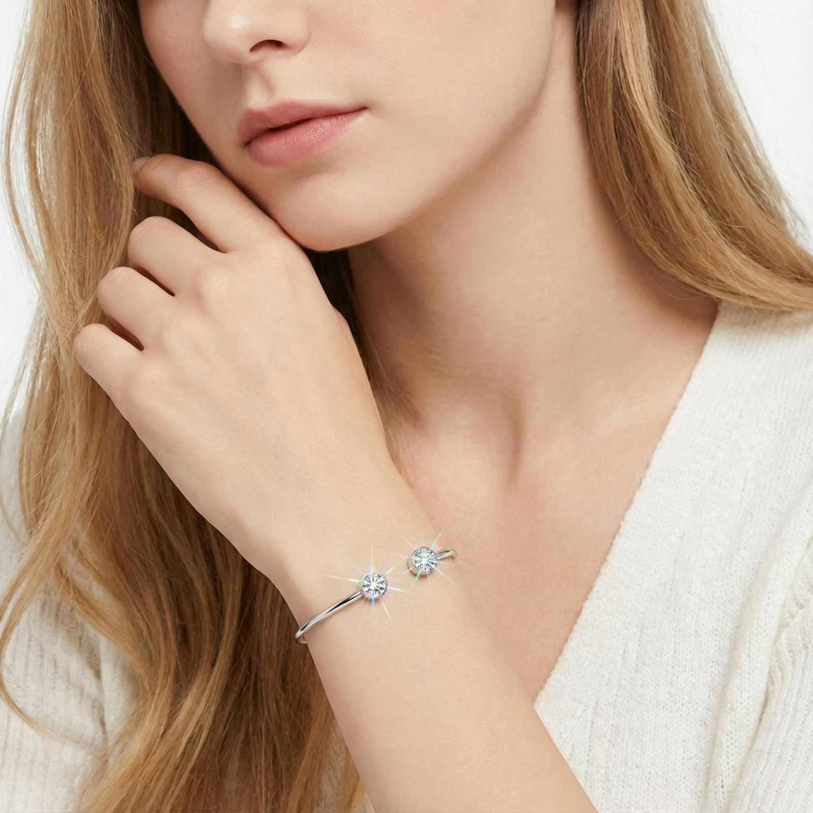 Silver stainless steel cuff bracelet with round-cut simulated diamonds worn on a woman's wrist.