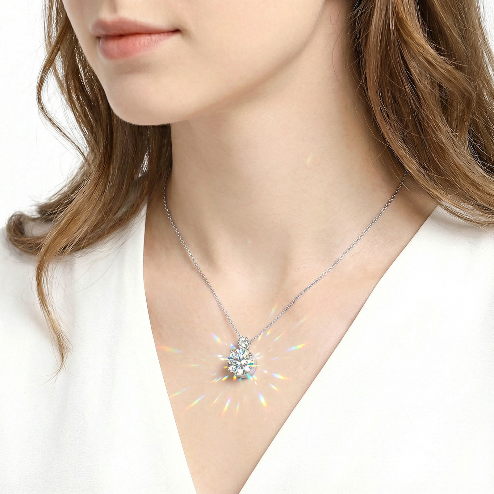Woman wearing the sterling silver Luciana pendant necklace with a brilliant round-cut simulated diamond.