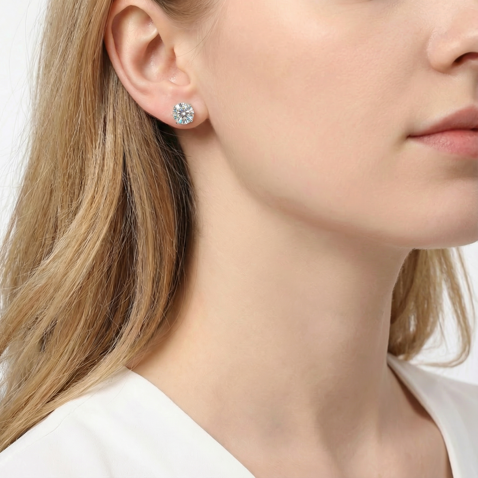 Woman wearing a round cut simulated diamond stud earring in S925 sterling silver.
