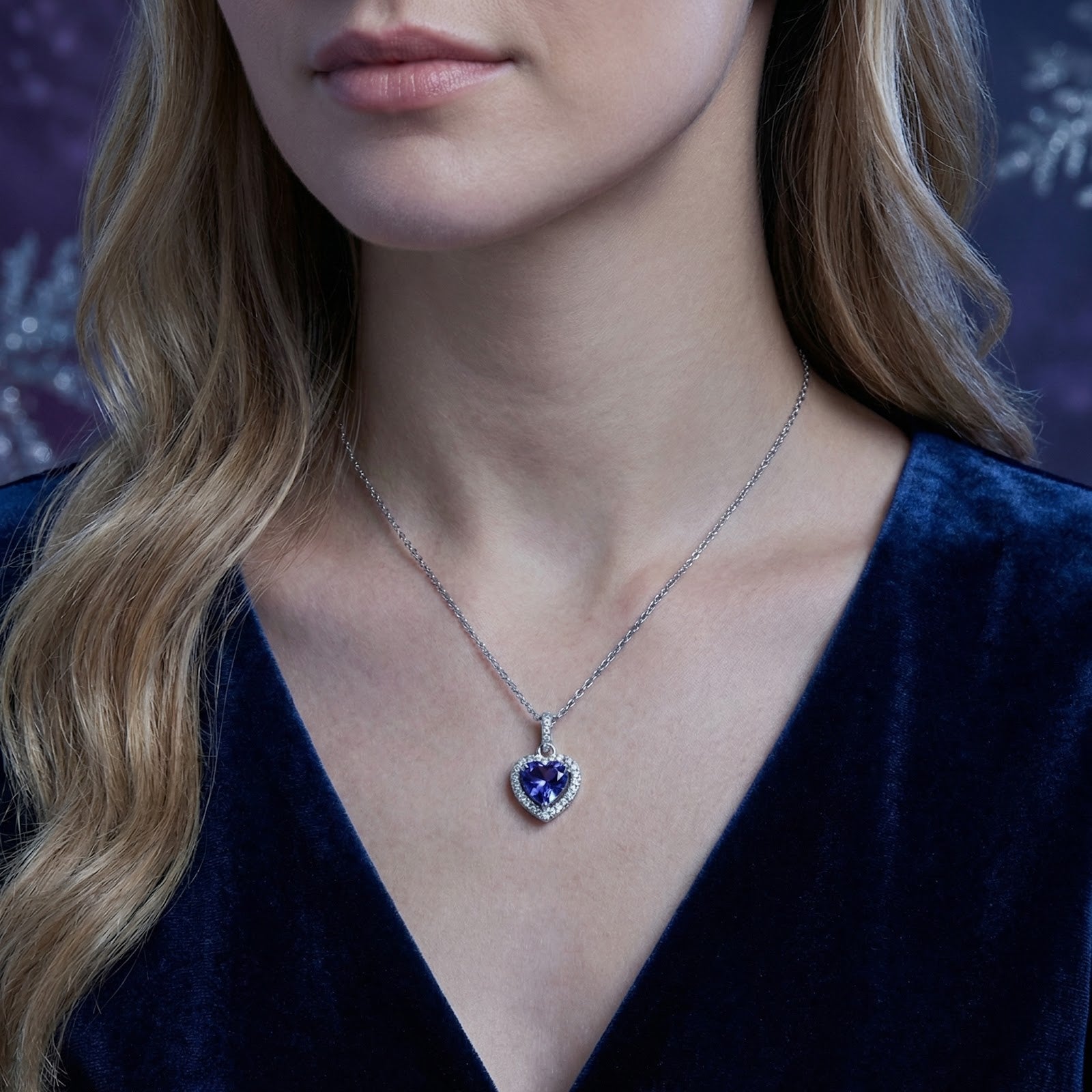 Front view of a woman wearing the heart-cut simulated tanzanite pendant in S925 sterling silver.