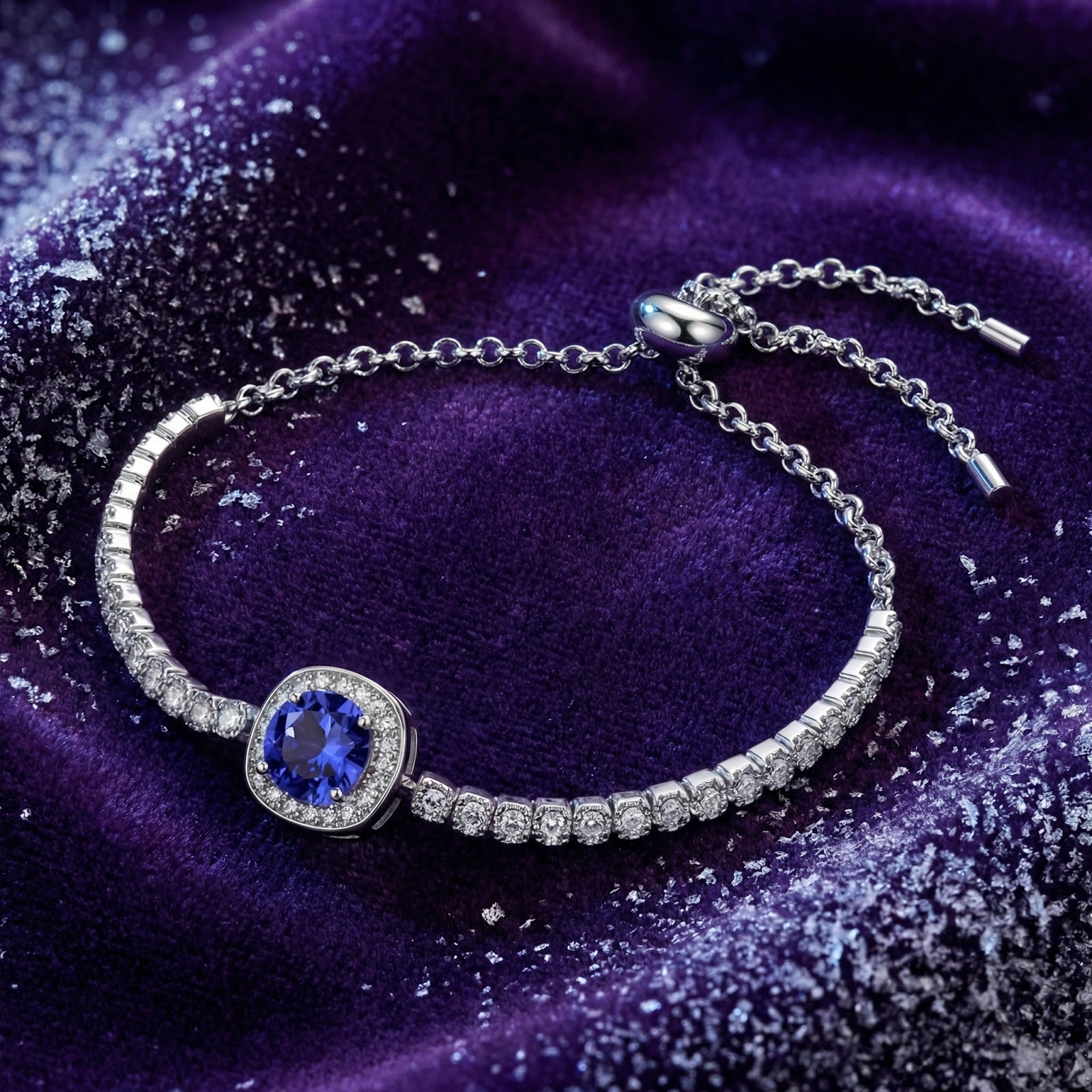 Sterling silver halo bracelet with a blue simulated tanzanite stone on a purple velvet background.