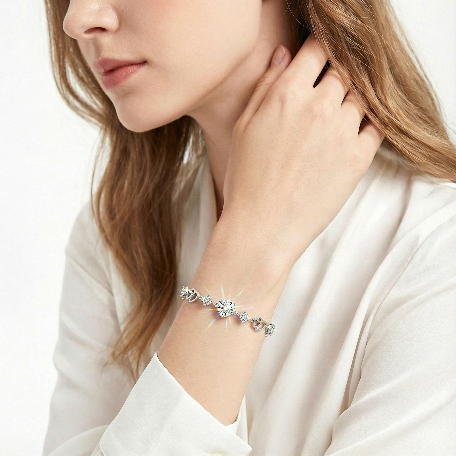 Woman wearing the S925 sterling silver Elaraea heart bracelet with sparkling round simulated diamonds on her wrist.