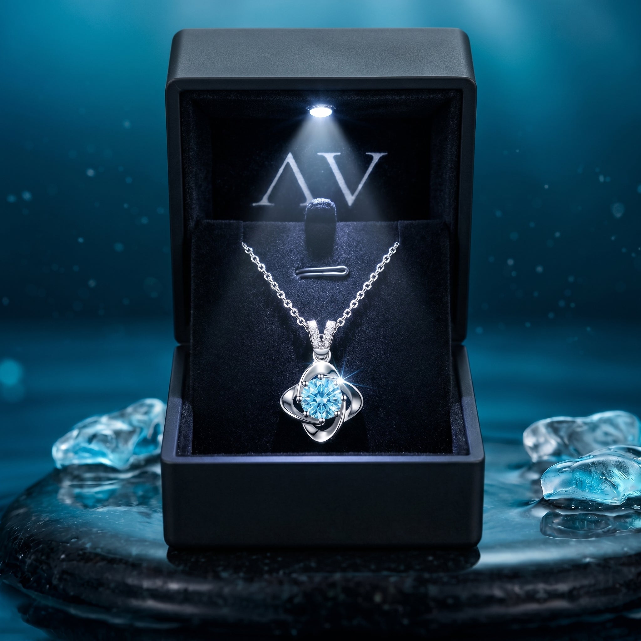 Round cut aquamarine platinum necklace presented in a luxury black illuminated gift box with branded interior.