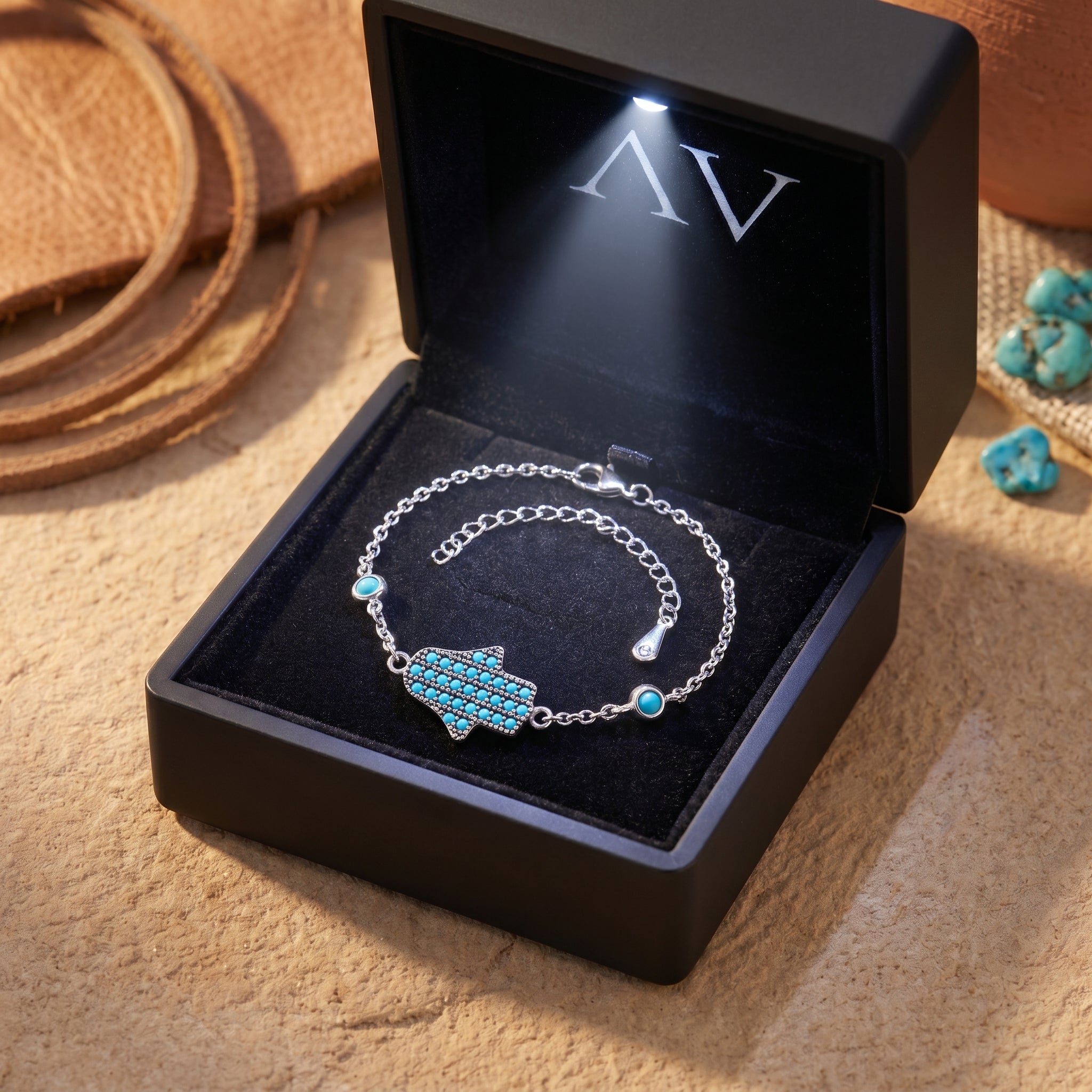 Silver turquoise Hamsa bracelet presented in a luxury black light-up gift box.