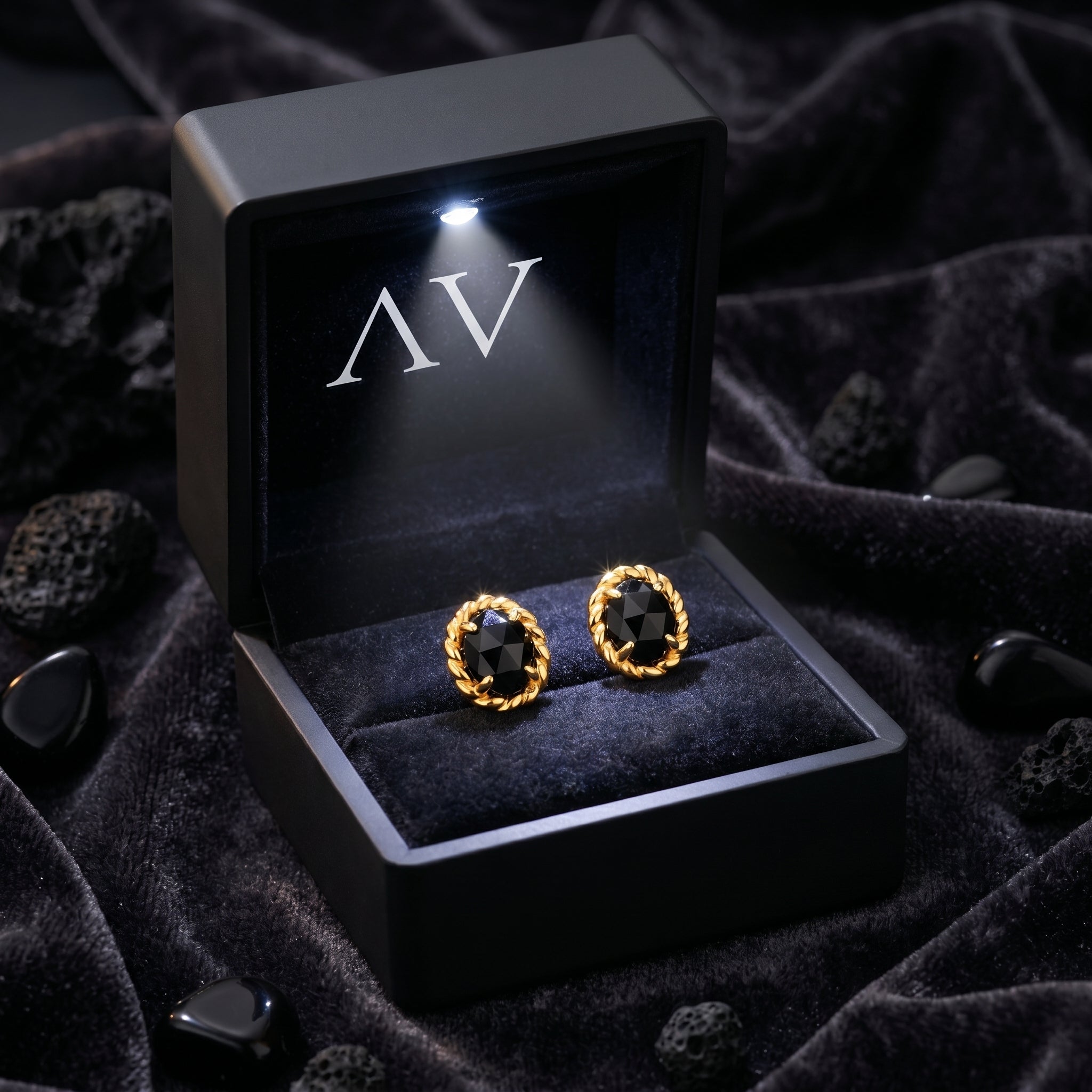 Natural onyx oval twist earrings displayed in a premium black LED-lighted gift box with velvet lining.