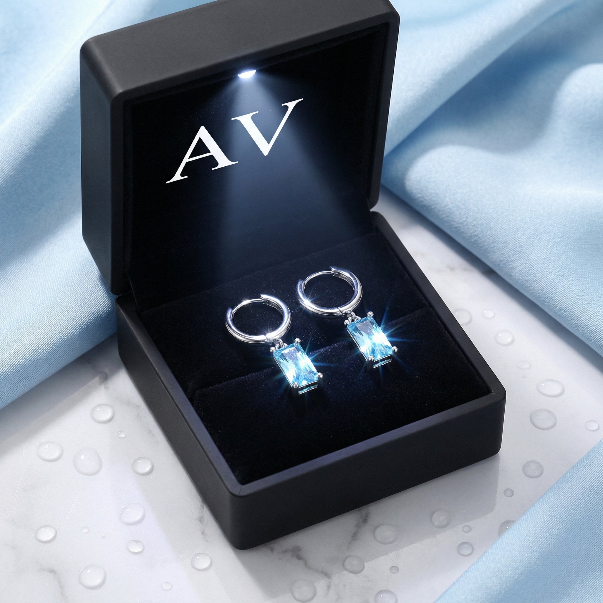 S925 sterling silver simulated aquamarine drop earrings inside a black LED-lit branded jewelry presentation box.