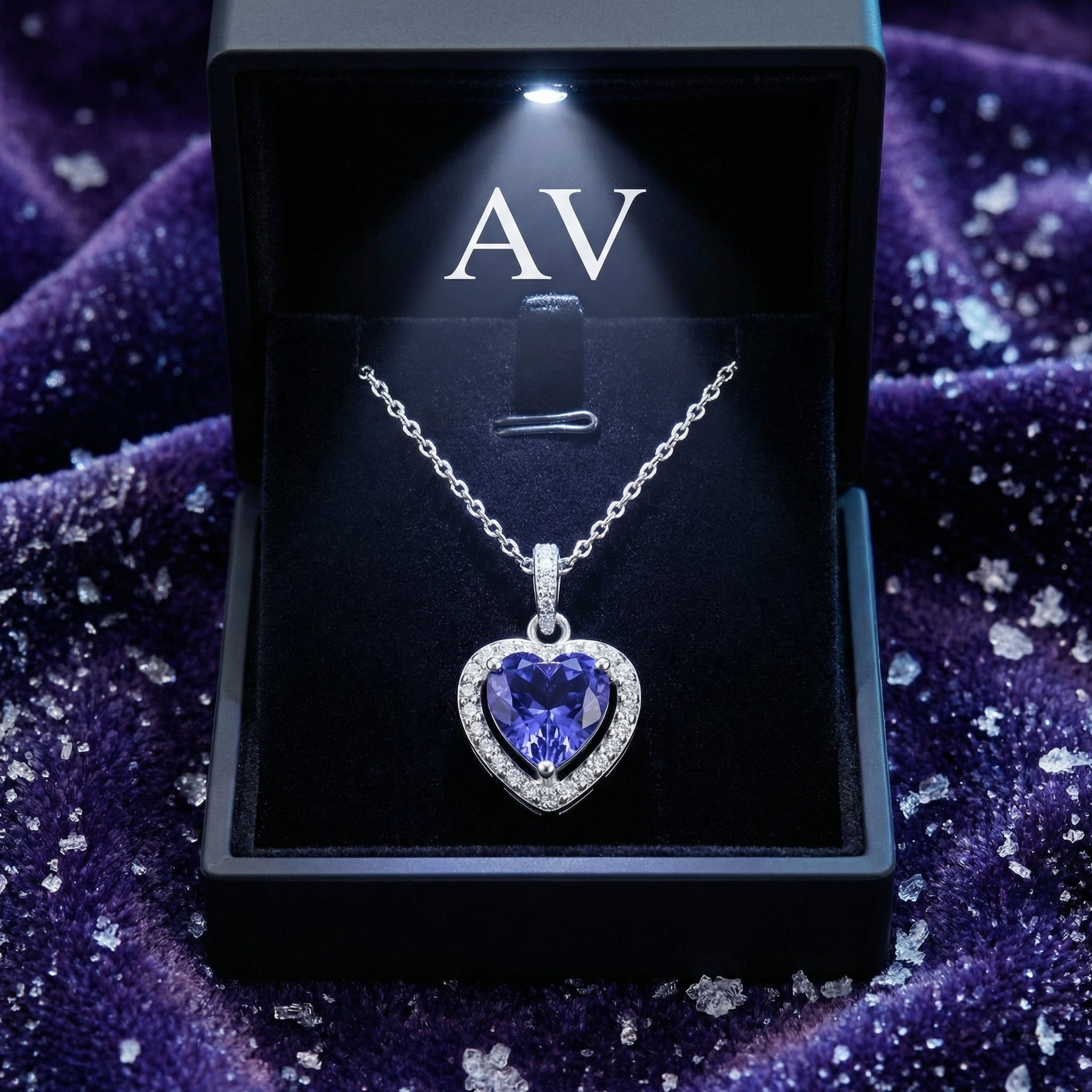 Heart-cut simulated tanzanite S925 sterling silver necklace inside a lighted black gift box.