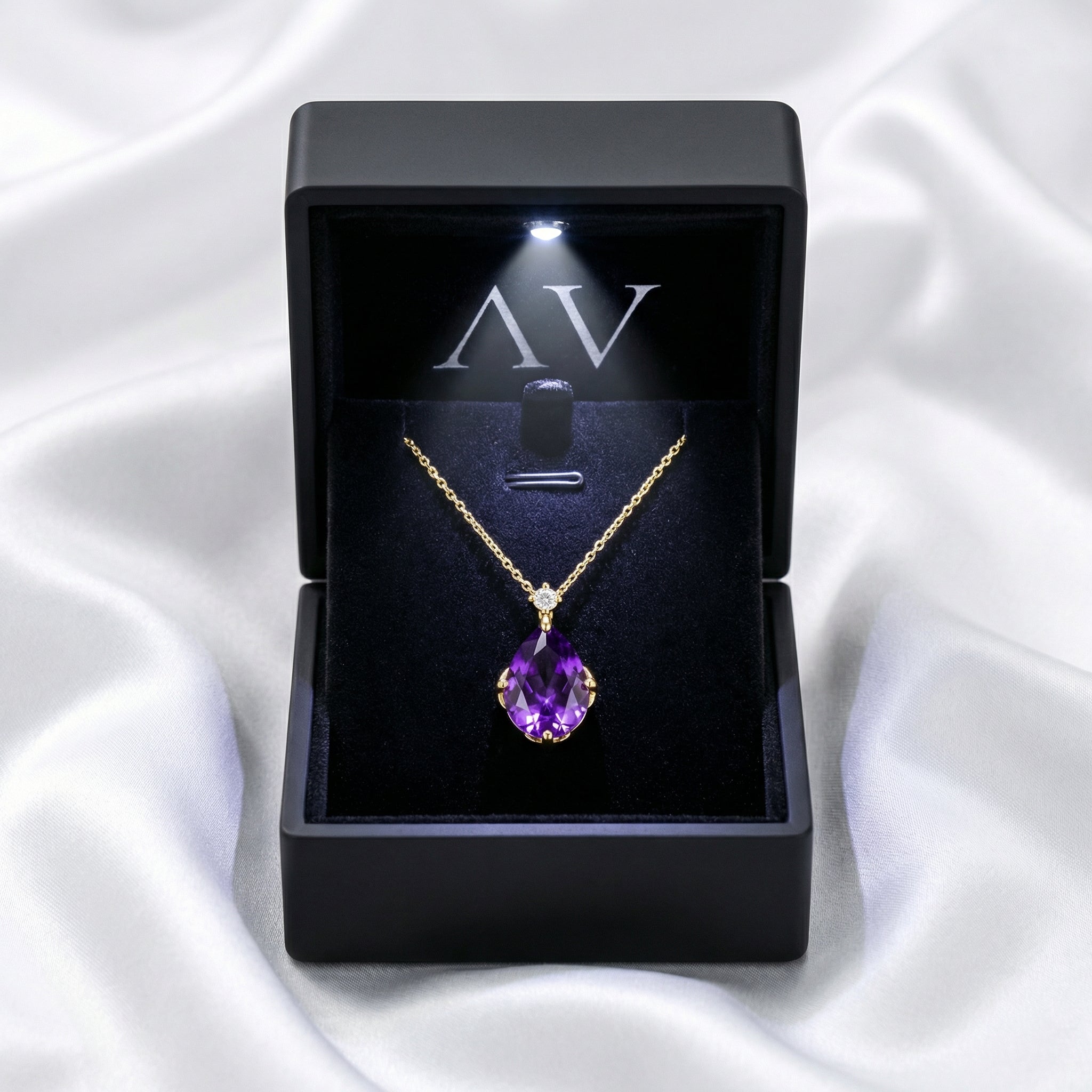 Simulated amethyst teardrop necklace in 18K gold vermeil inside a black LED-lit gift box.