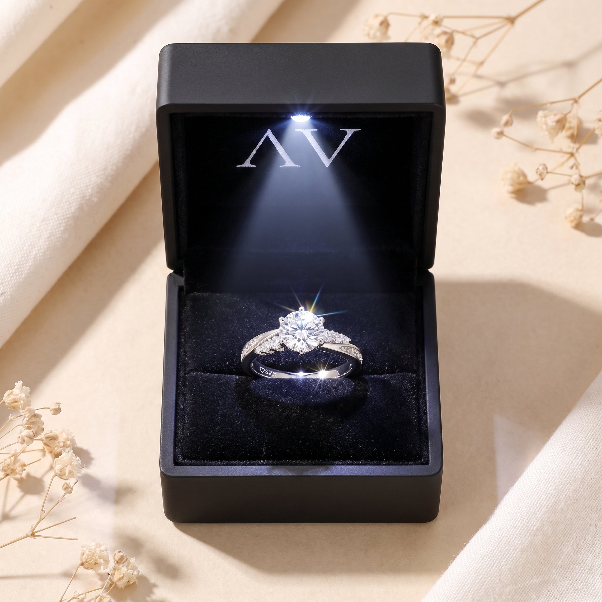 Sterling silver Nicolette moissanite ring in a black LED-lit gift box with a velvet interior.