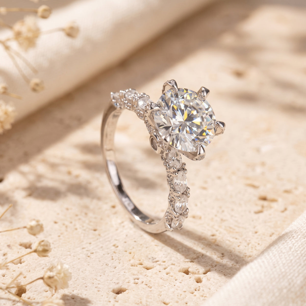 Round cut solitaire promise ring in S925 sterling silver on a textured stone surface.