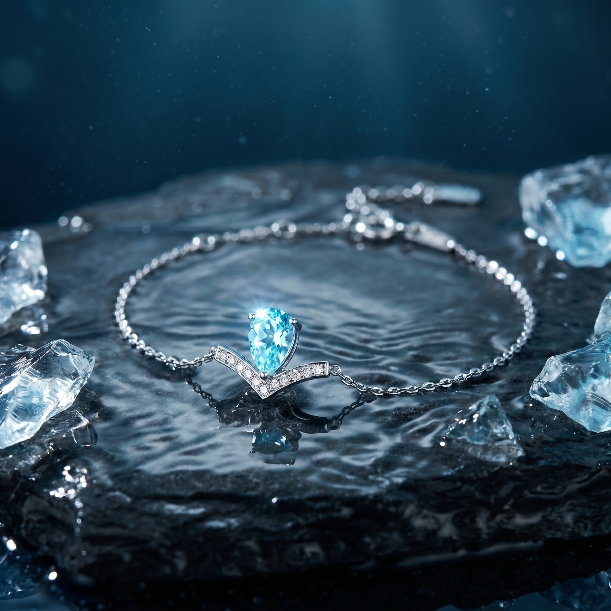 Pear-cut natural aquamarine Pt950 platinum bracelet with diamond accents in a circle on a dark wet rock with ice.