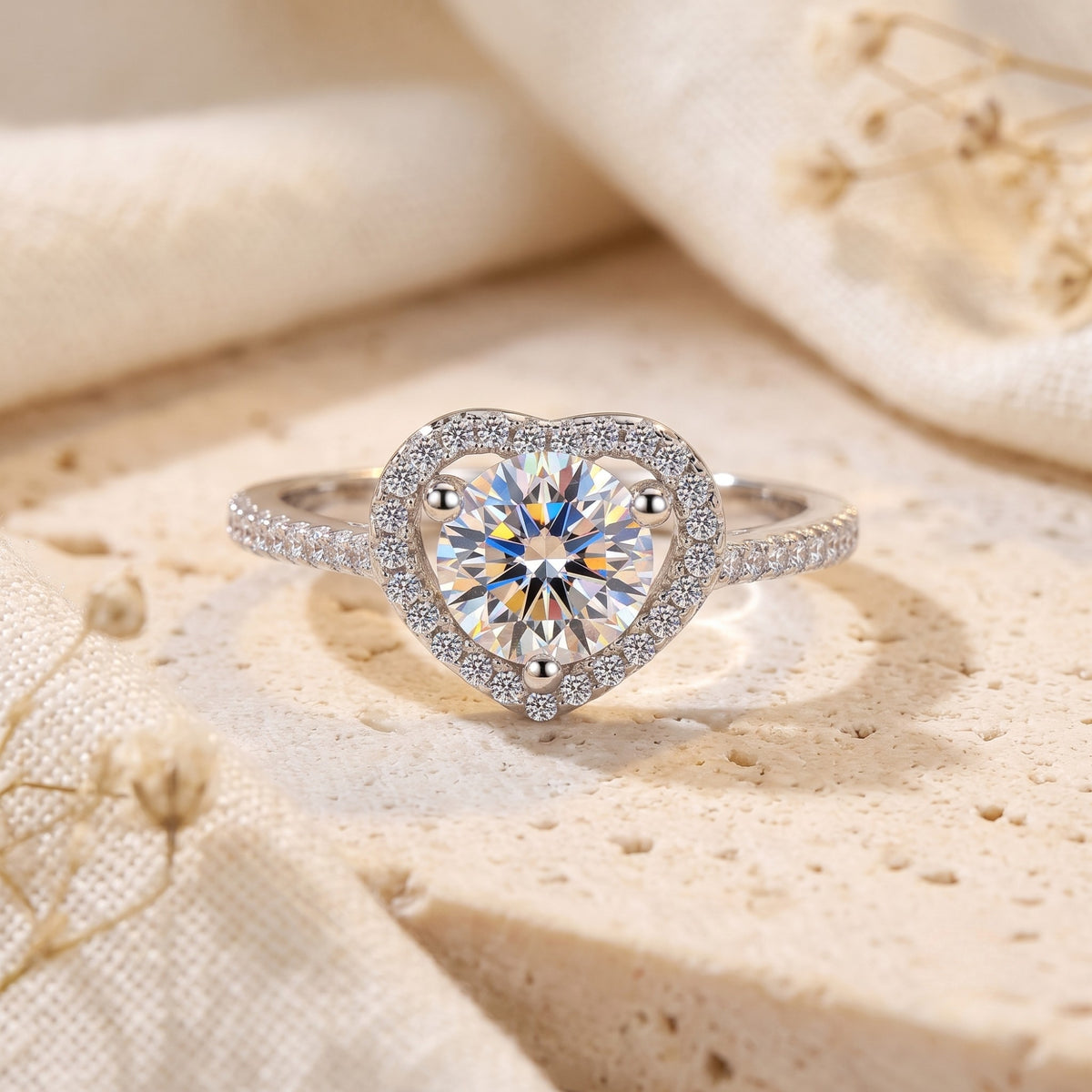 S925 sterling silver heart halo ring with round cubic zirconia on a textured lifestyle background.