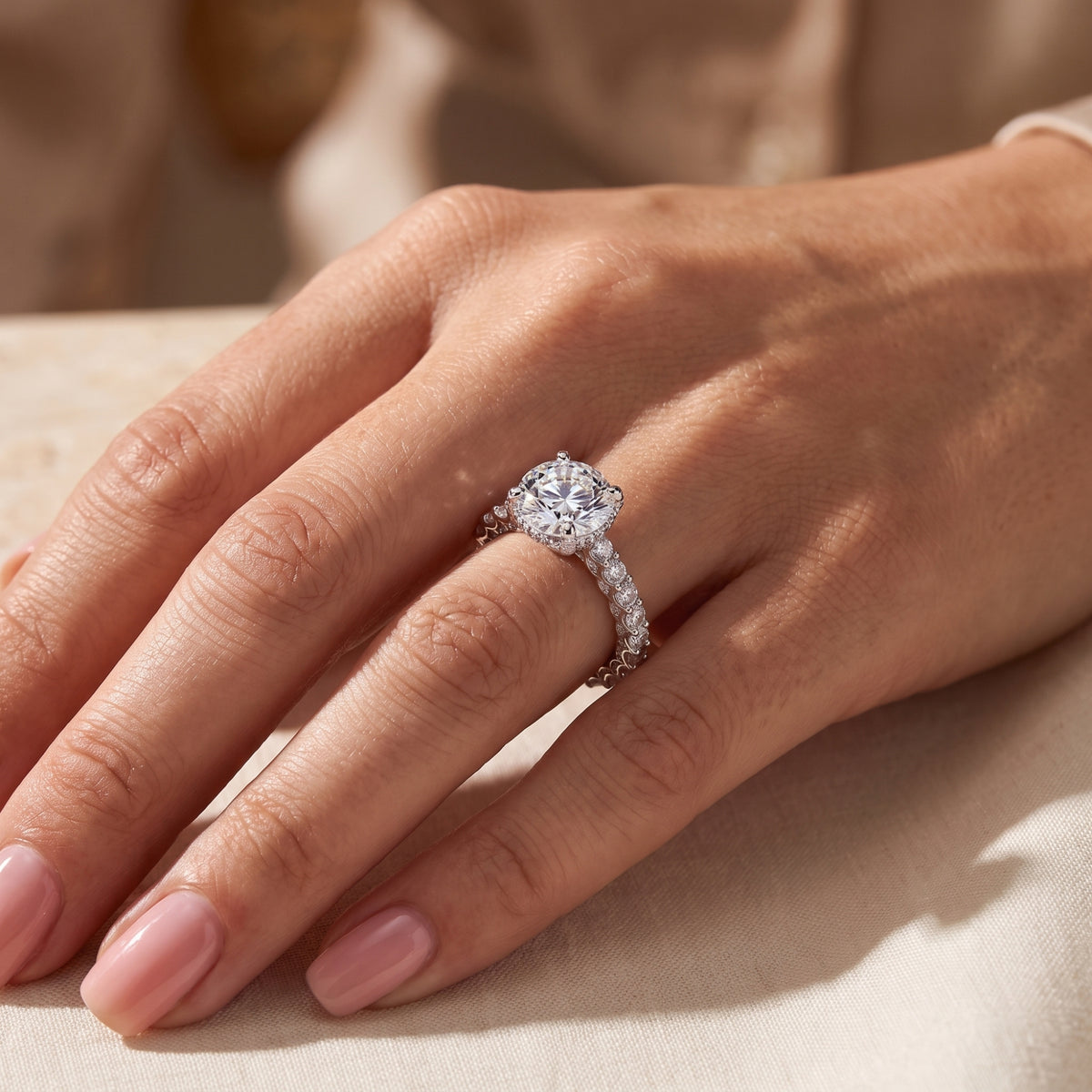The silver hidden halo ring worn on a hand, viewed from above.