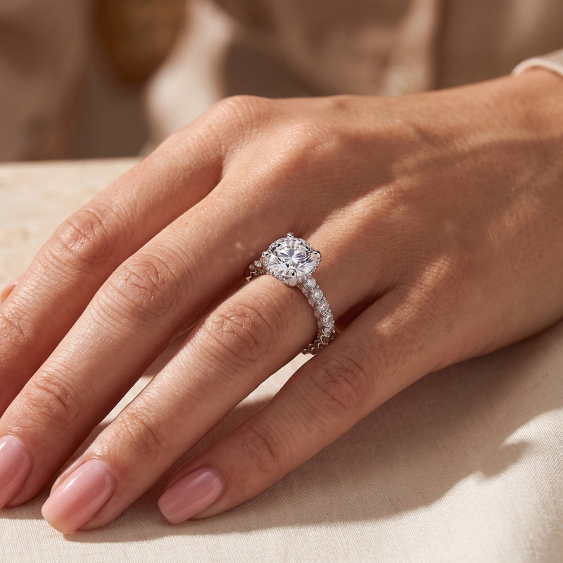 The silver hidden halo ring worn on a hand, viewed from above.