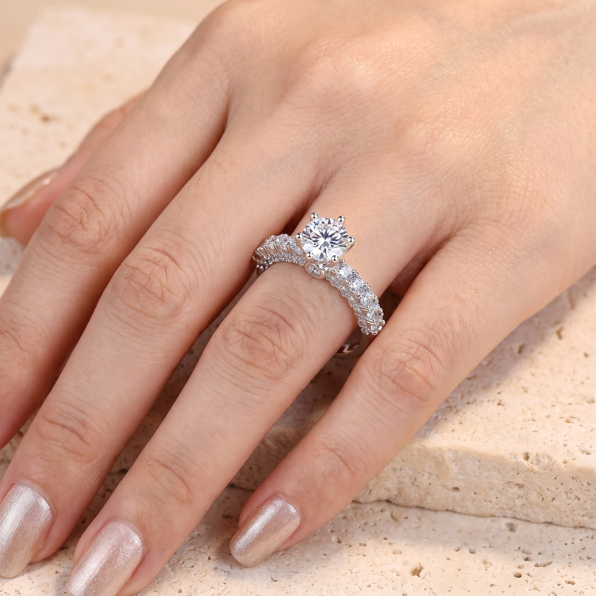 Round brilliant-cut cubic zirconia silver ring shown on a hand.