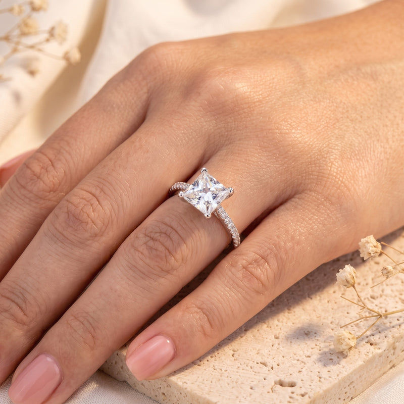 Hand wearing a 14K or 18K solid gold ring with a square princess-cut natural zircon central stone and pave-set accents along the band.