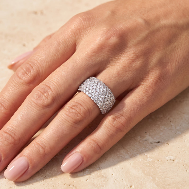 Top-down view of a hand wearing the wide silver cobblestone pave ring on a finger.