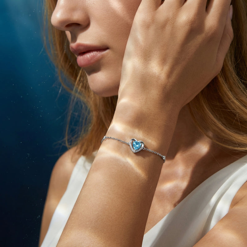 Heart cut aquamarine platinum bracelet worn on a woman's wrist, capturing the light in a lifestyle setting.