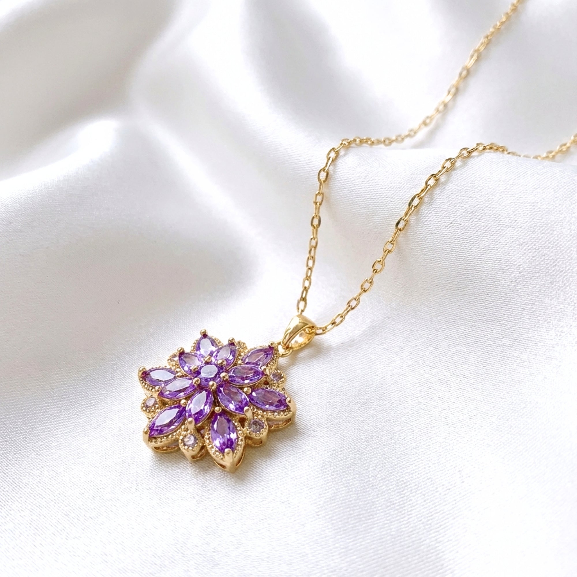 Side detail of the gold-finished stainless steel Floriana pendant necklace with purple simulated amethyst.