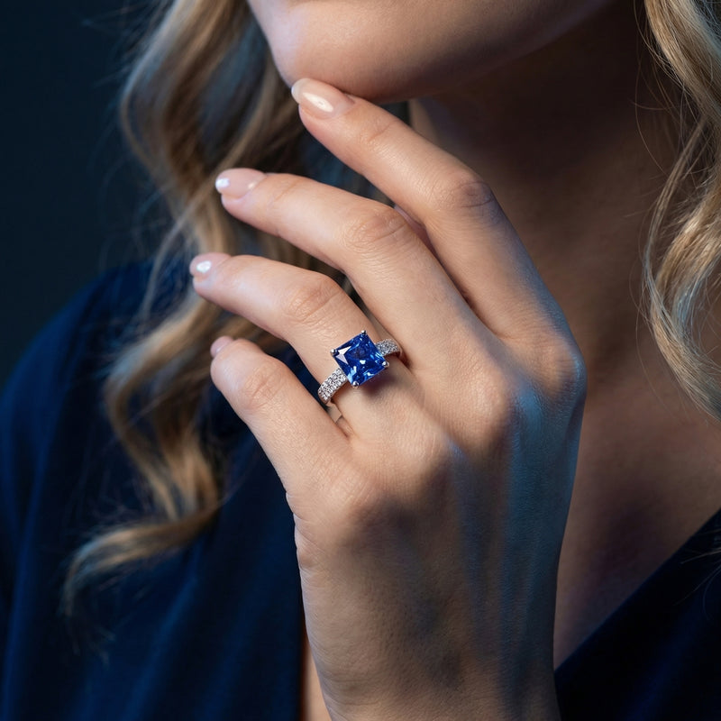 Model wearing the Gwendolyn princess cut tanzanite ring in sterling silver on her ring finger.