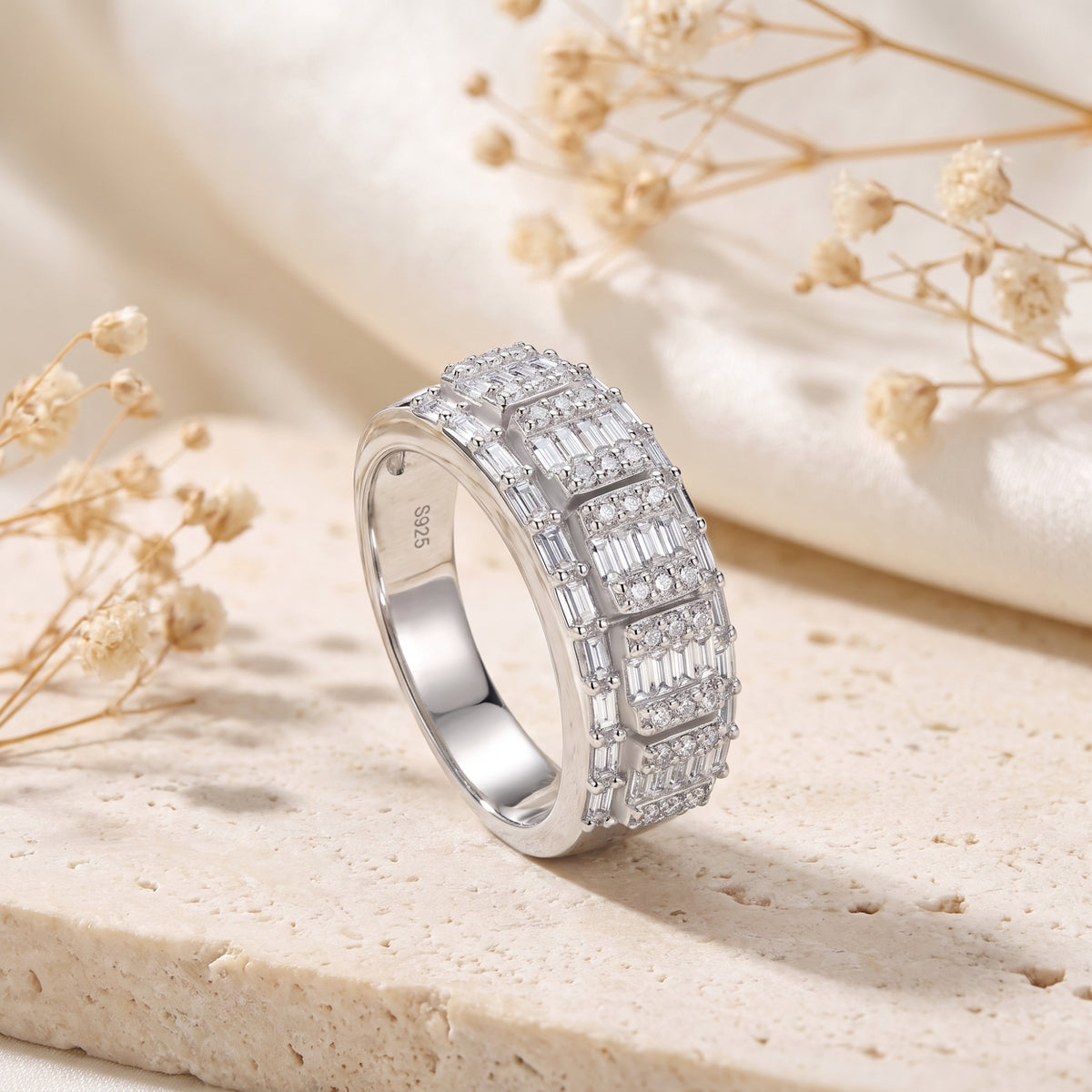 Angled close-up of the silver mosaic ring on a beige stone surface, showing the inner S925 stamp.