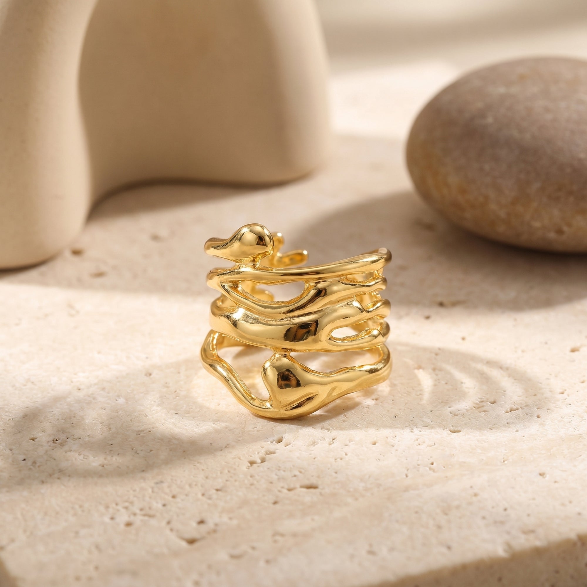 Close-up of the gold Marinella ring's organic, liquid-like band structure.