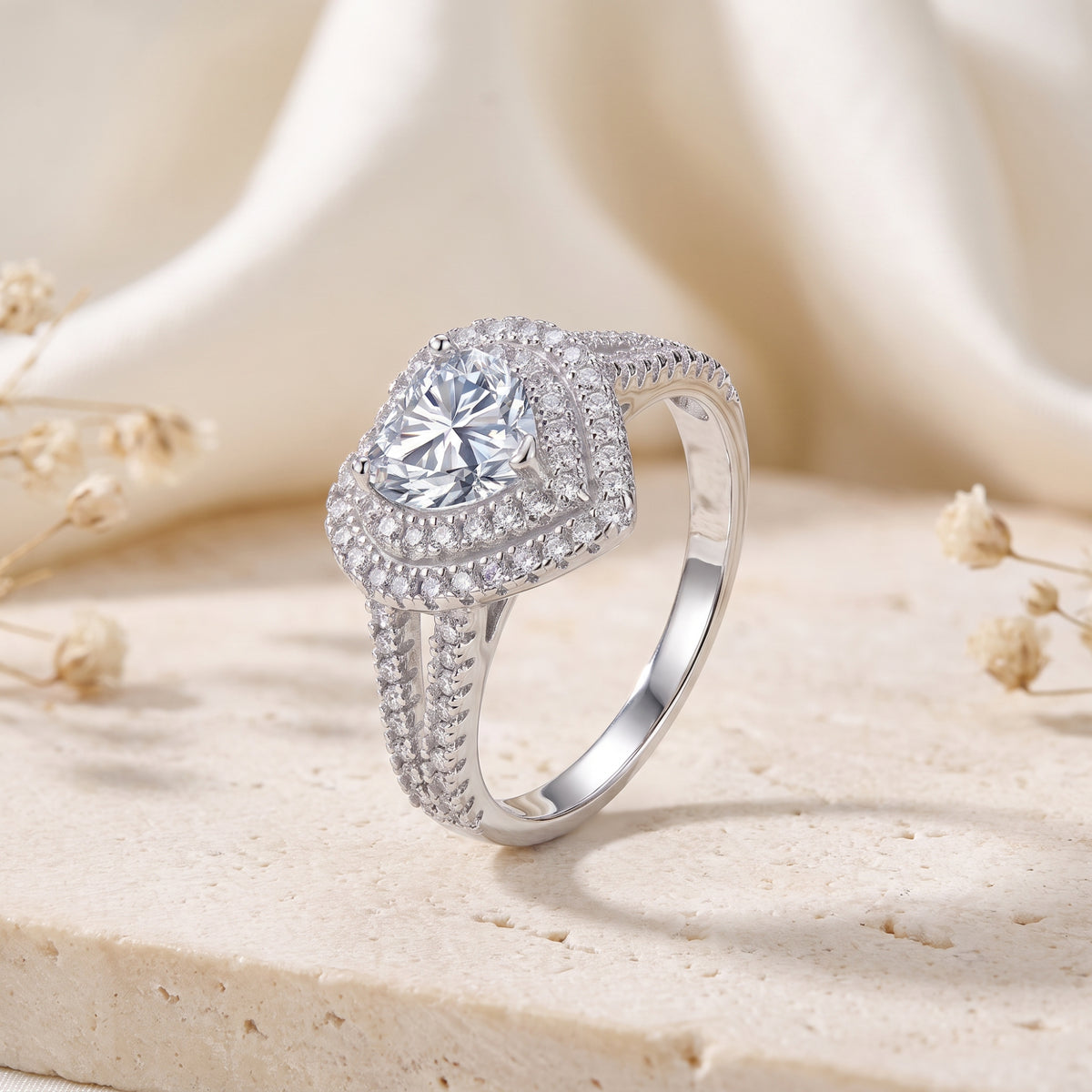 Three-quarter view of the silver double halo ring, highlighting the heart-cut clear stone and profile.