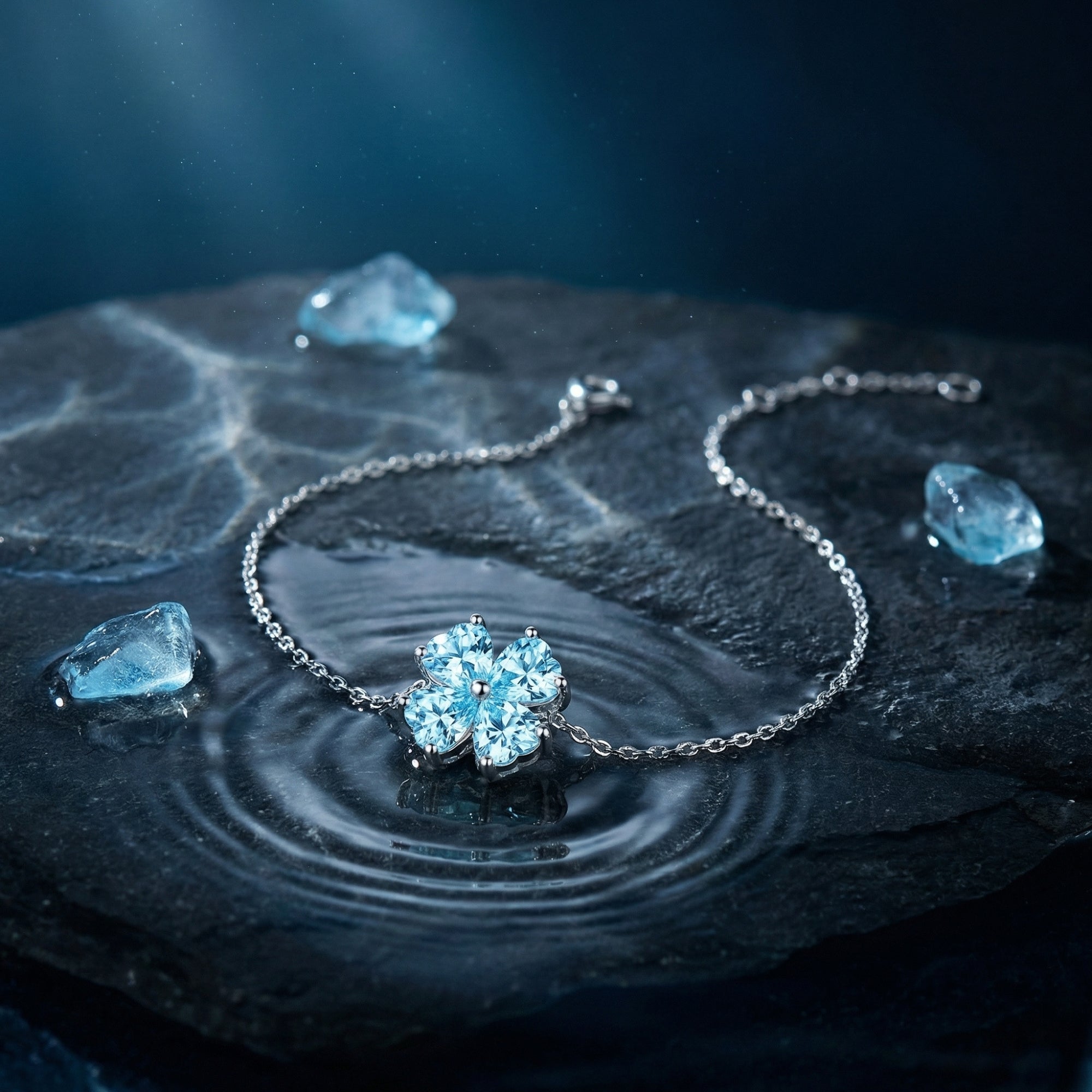 Macro view of the heart-cut aquamarine station on a platinum chain bracelet over a rippled water surface.