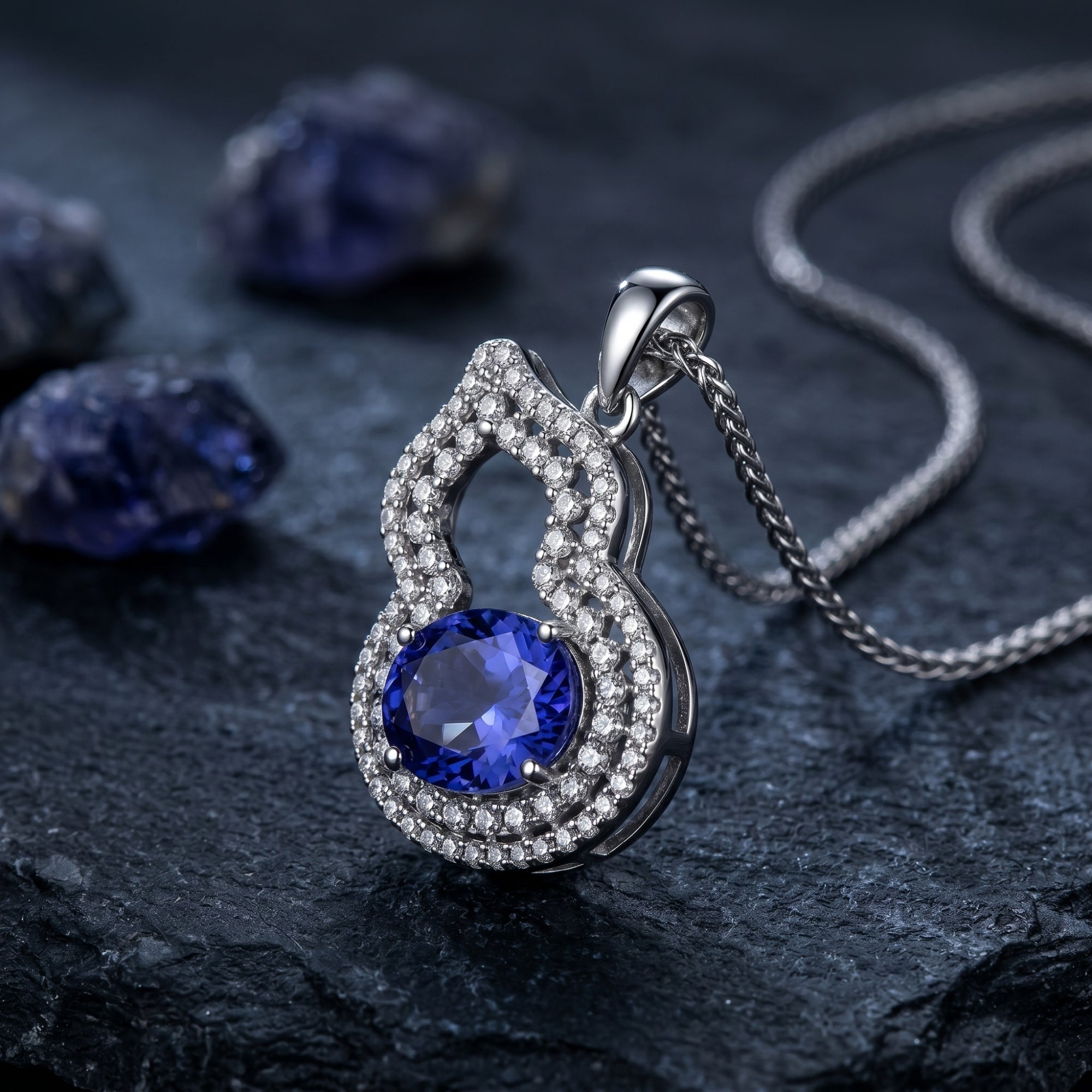 Close-up of an oval natural tanzanite halo pendant in white gold, showing the intricate micro-pave setting.
