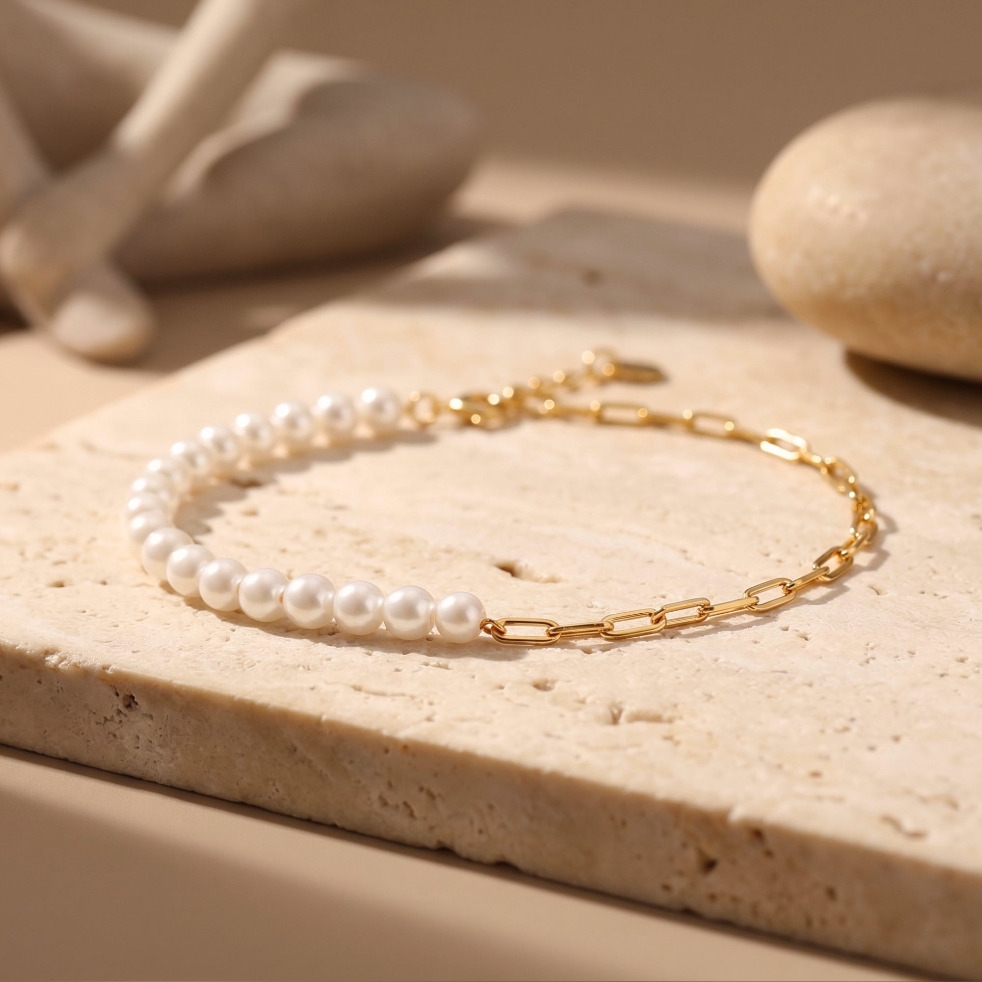 Close-up of the 18K gold plated O-chain and round white pearls on the Lenora bracelet.