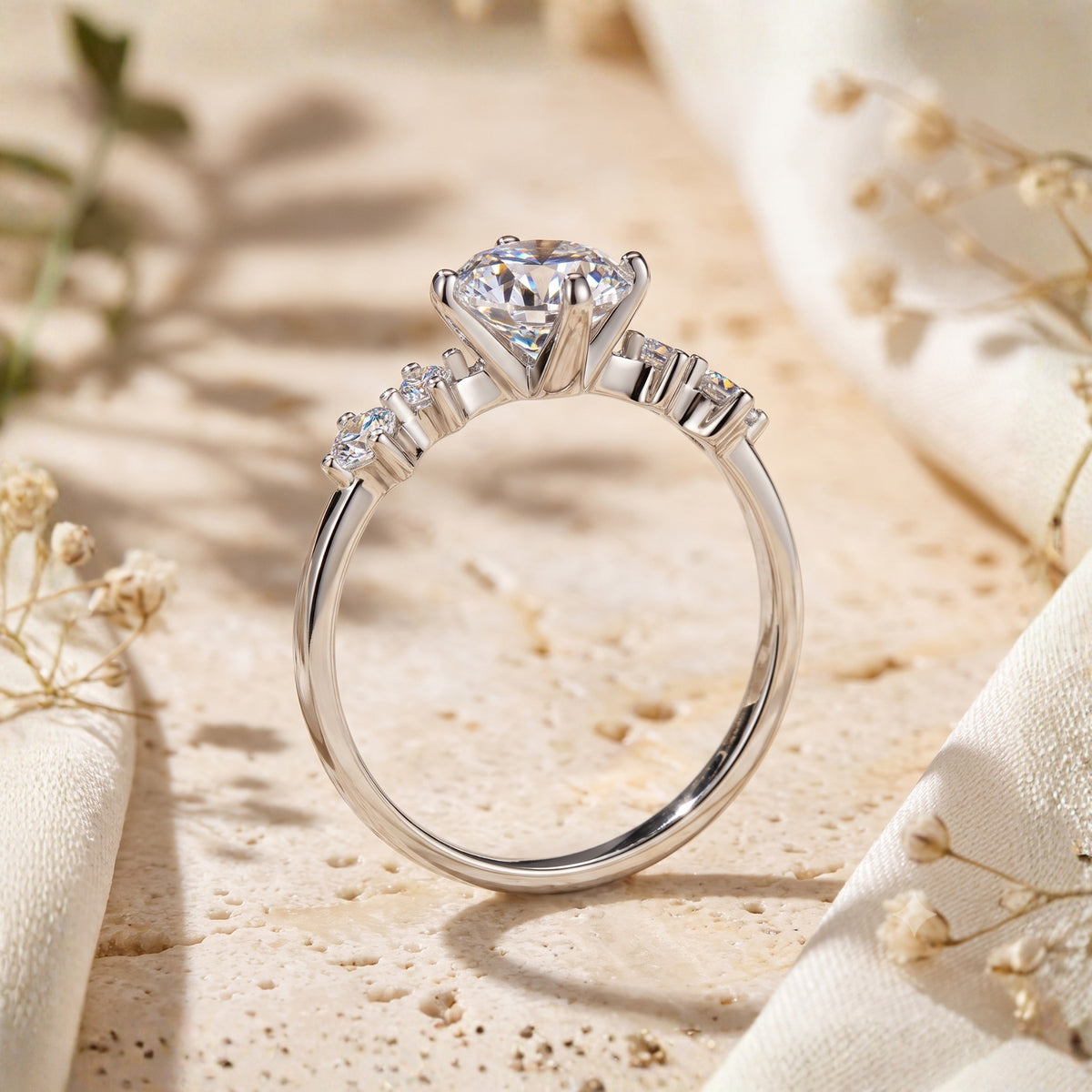 Side profile view showing the elevated prong setting and band of the silver solitaire ring.