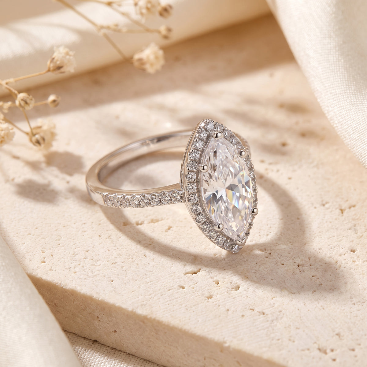 Side-profile view of the silver halo ring showcasing the raised marquise setting and pavé-set band.
