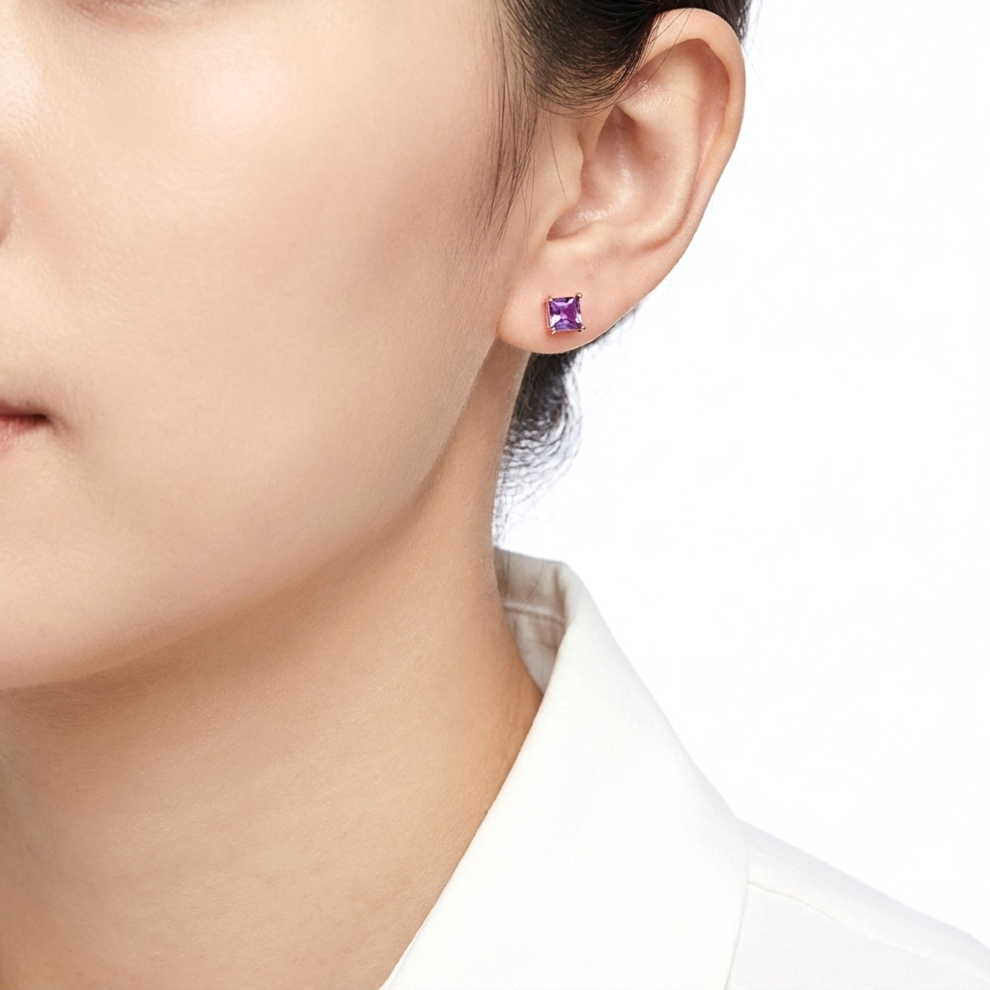 Model wearing a square cut simulated amethyst stud earring in 18K rose gold vermeil.