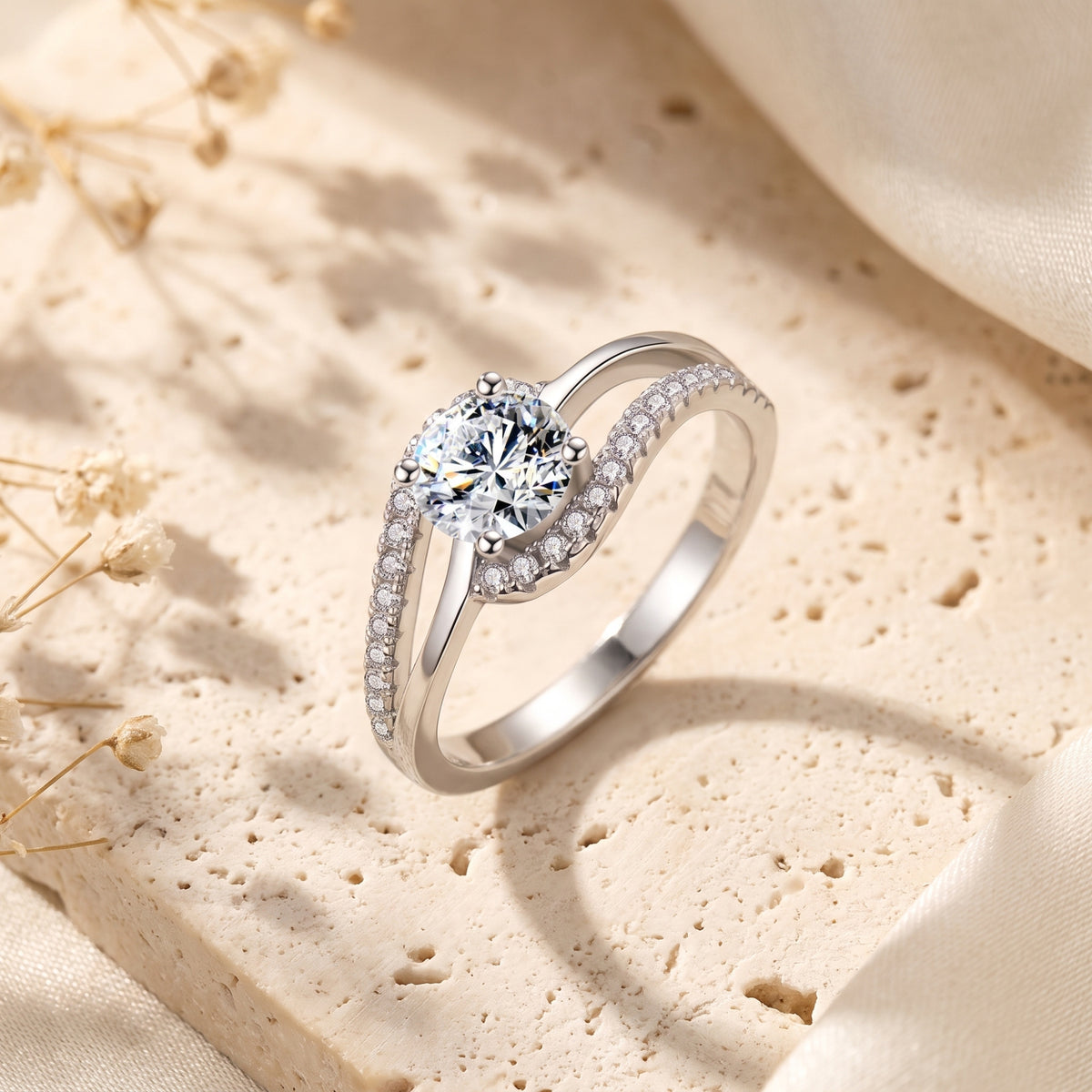 Angled studio view of the silver bypass ring highlighting its round center stone and split pavé band on stone.