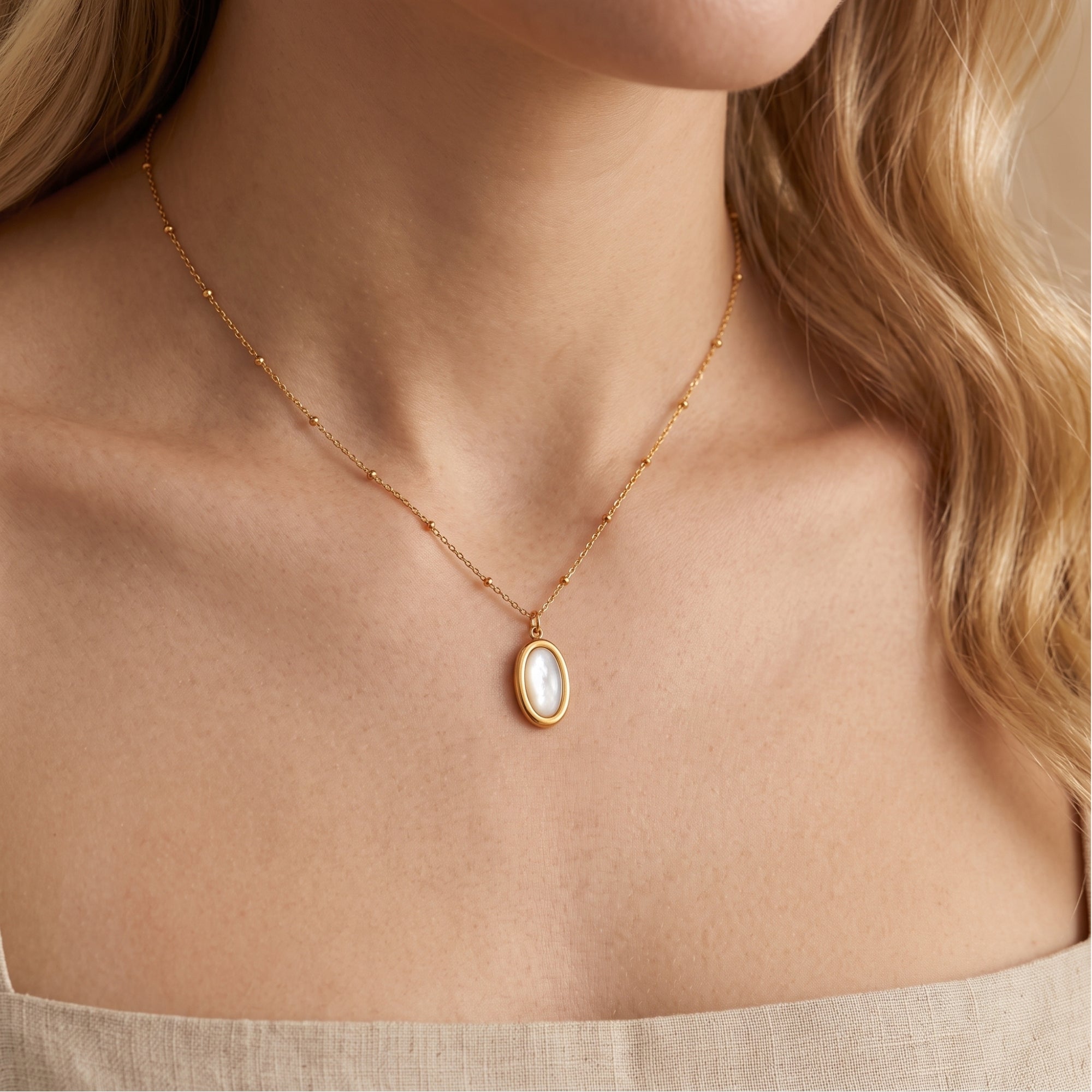 Front view of gold mother of pearl necklace on a model.