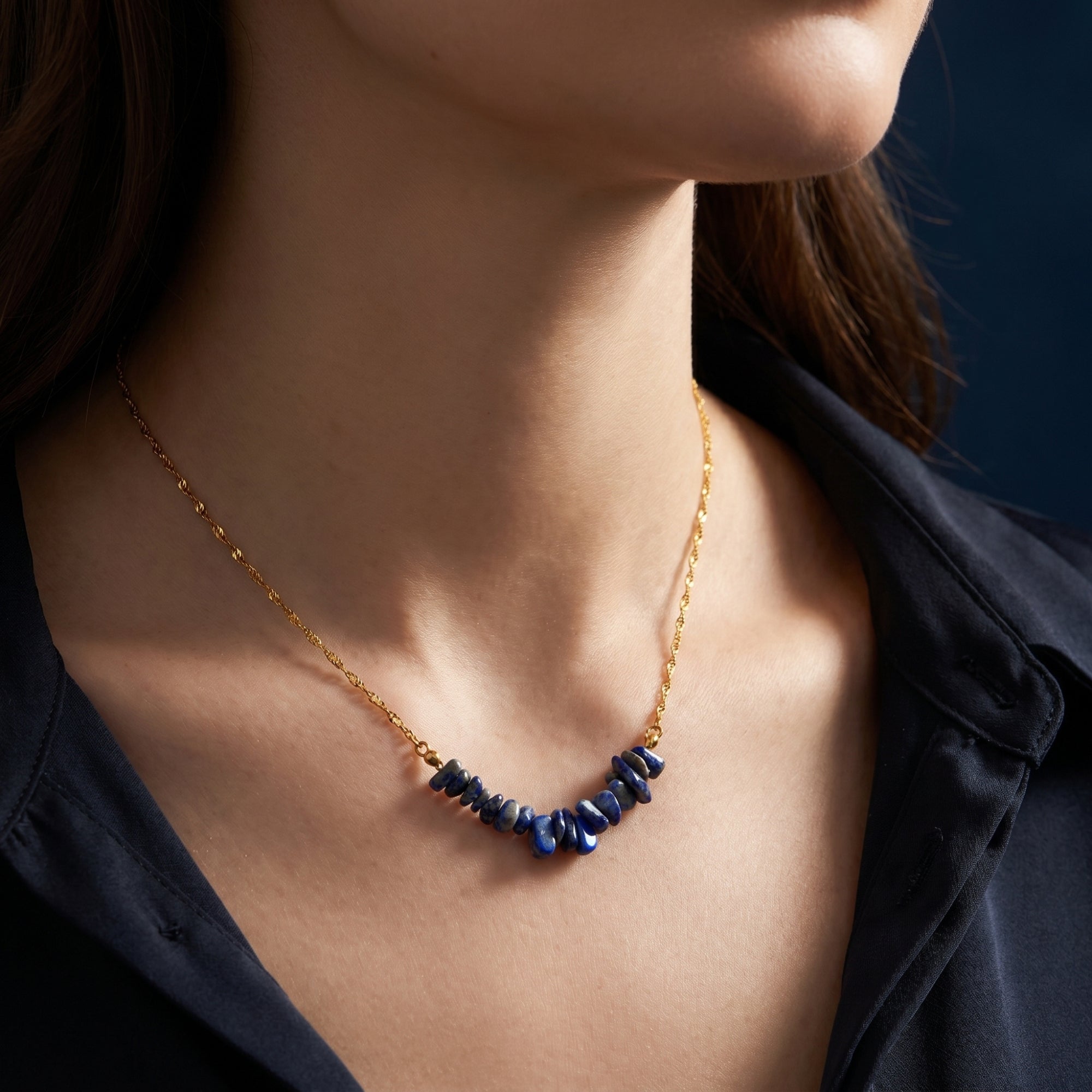 Natural lapis lazuli bar necklace in 18K gold plated stainless steel worn by a model.
