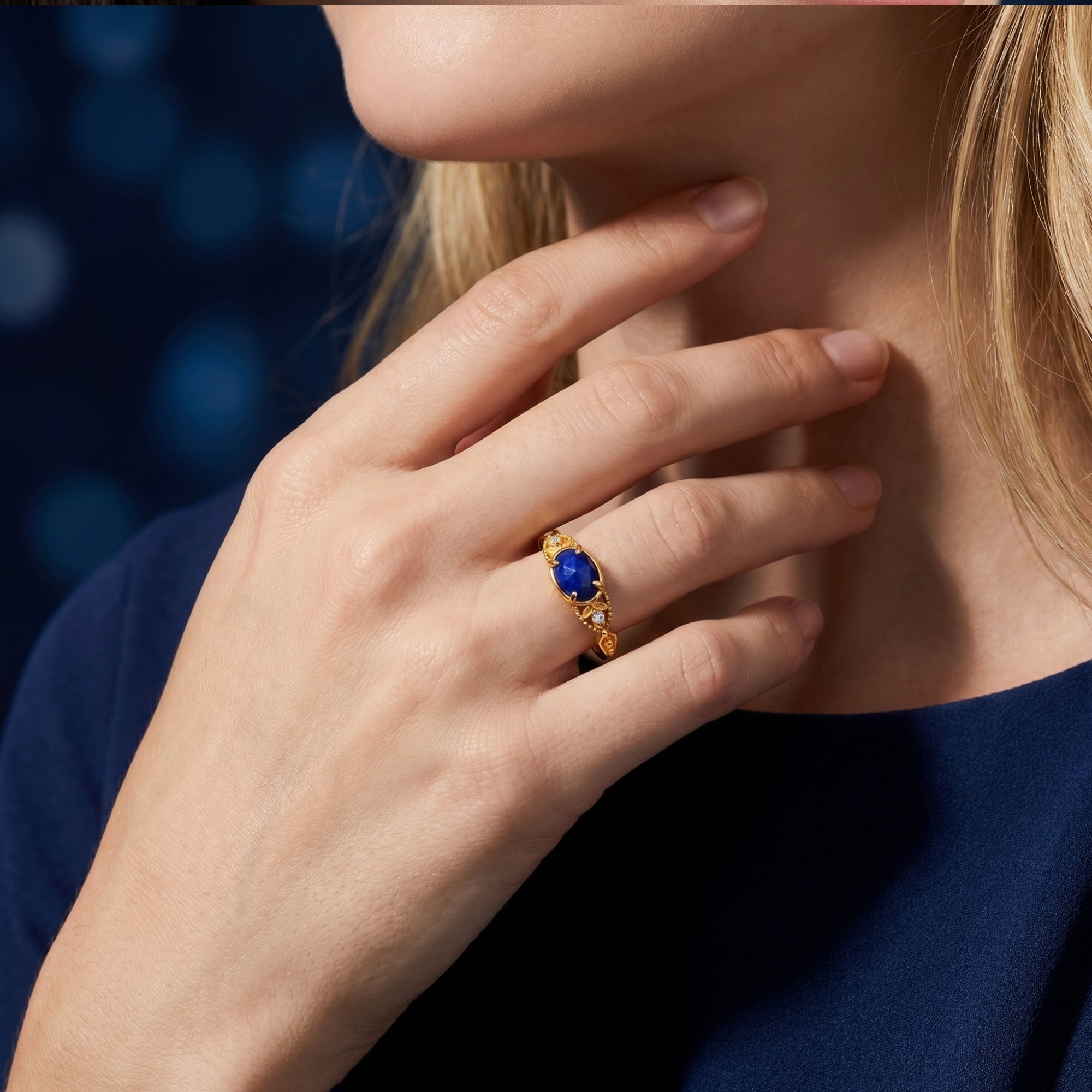 Gold Elarissa lapis lazuli ring worn by a model, highlighting the deep blue gemstone and gold band.